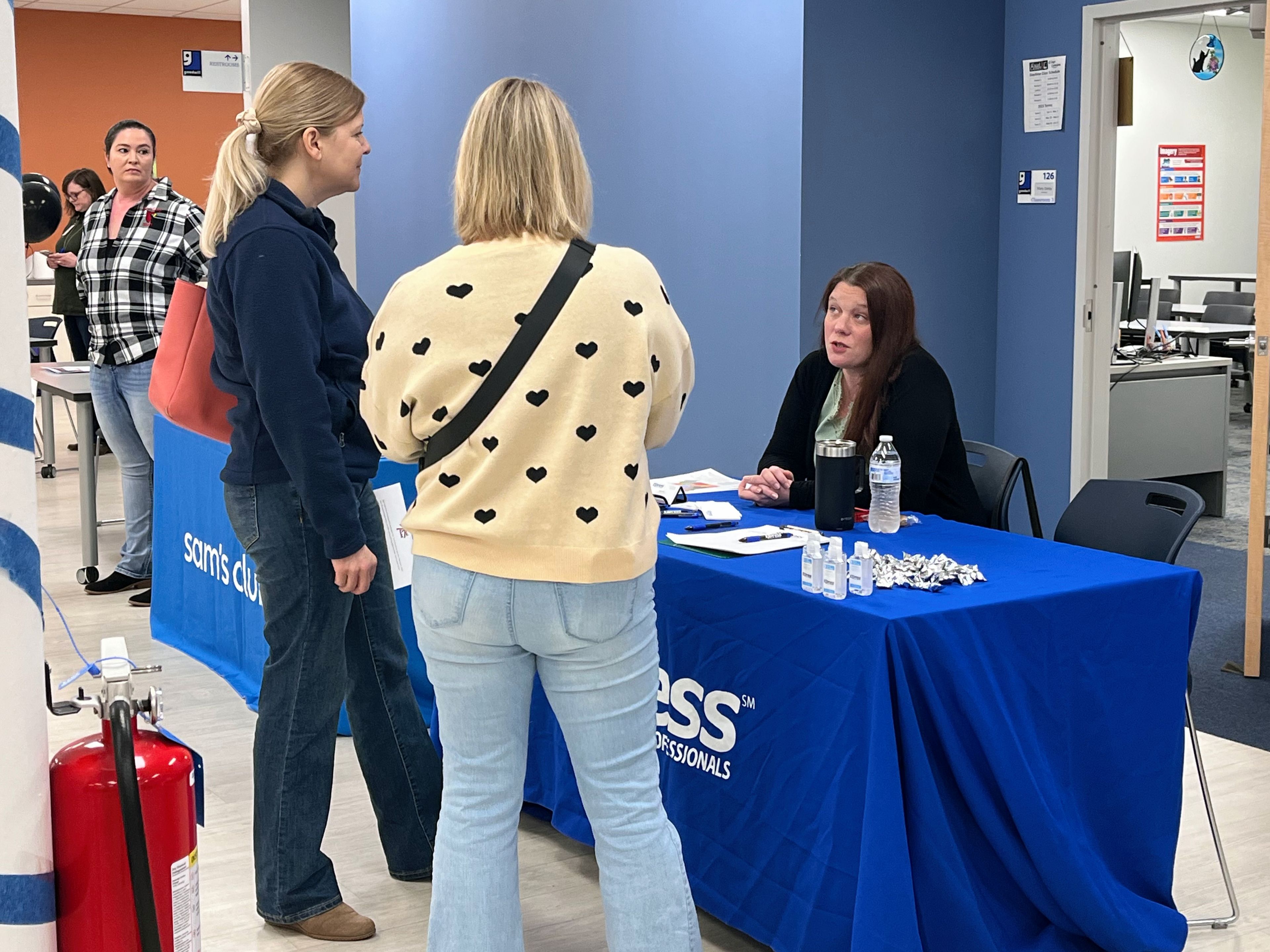 Katie Harbin, front office coordinator with Express Employment Professionals, discusses potential opportunities with Job, Education and Resource Fair attendees Friday, Nov. 15, at the MERS/Goodwill Excel Center in Cape Girardeau. 