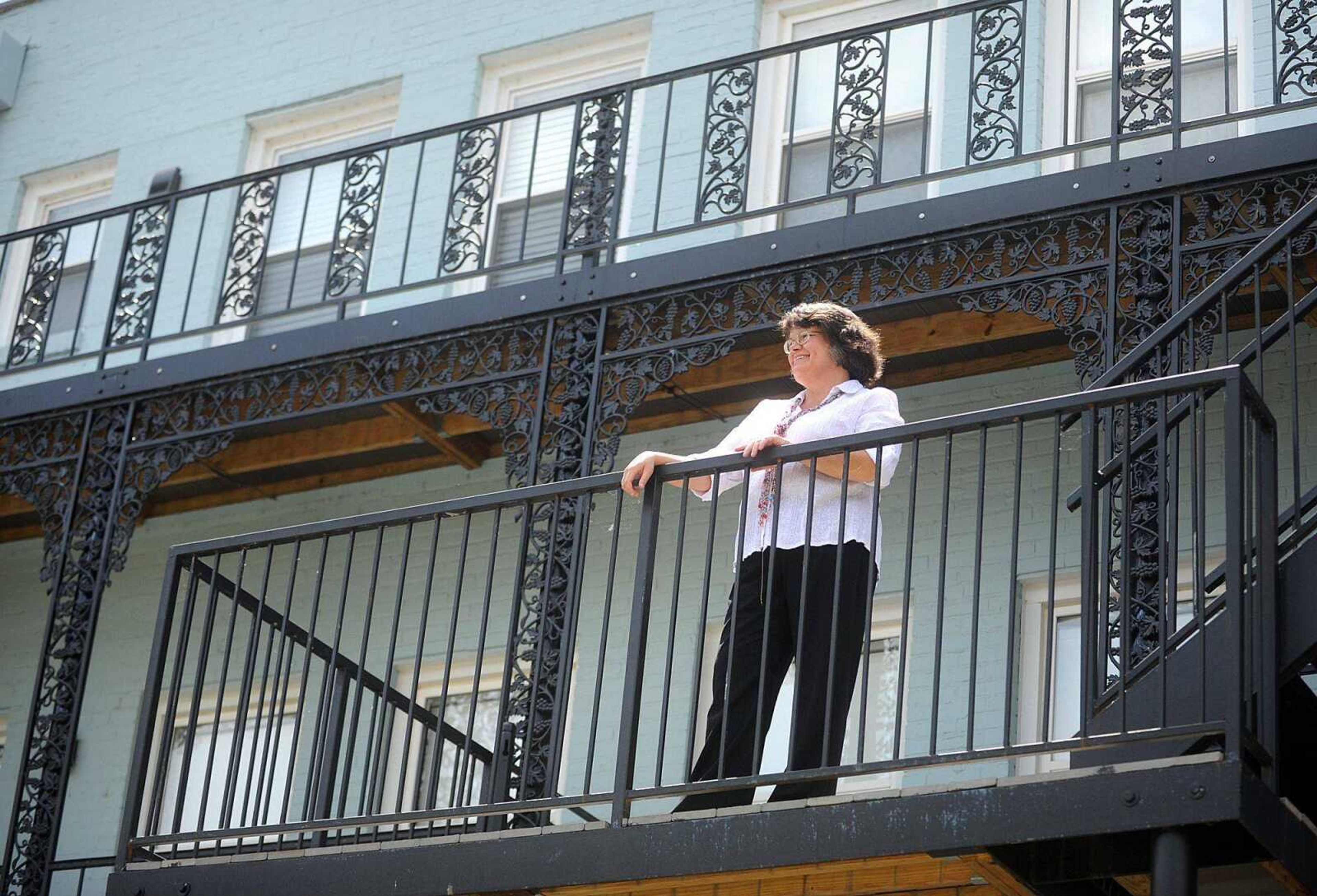 Rebecca Ward stands on the second-floor deck of the Vasterling Suites in Cape Girardeau. (Laura Simon)