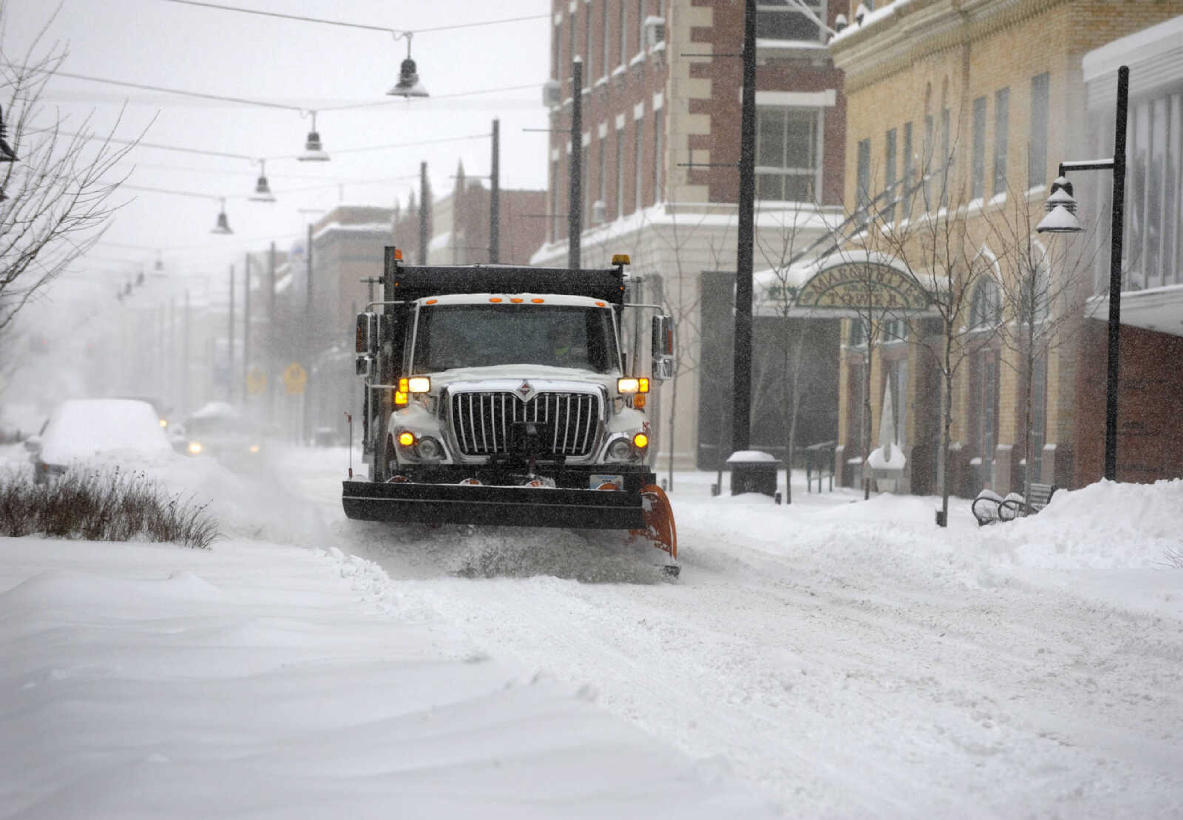 LAURA SIMON ~ lsimon@semissourian.com

A snow plow works to clear the westbound lane of Broadway Monday morning, Feb. 16, 2015, in Cape Girardeau.