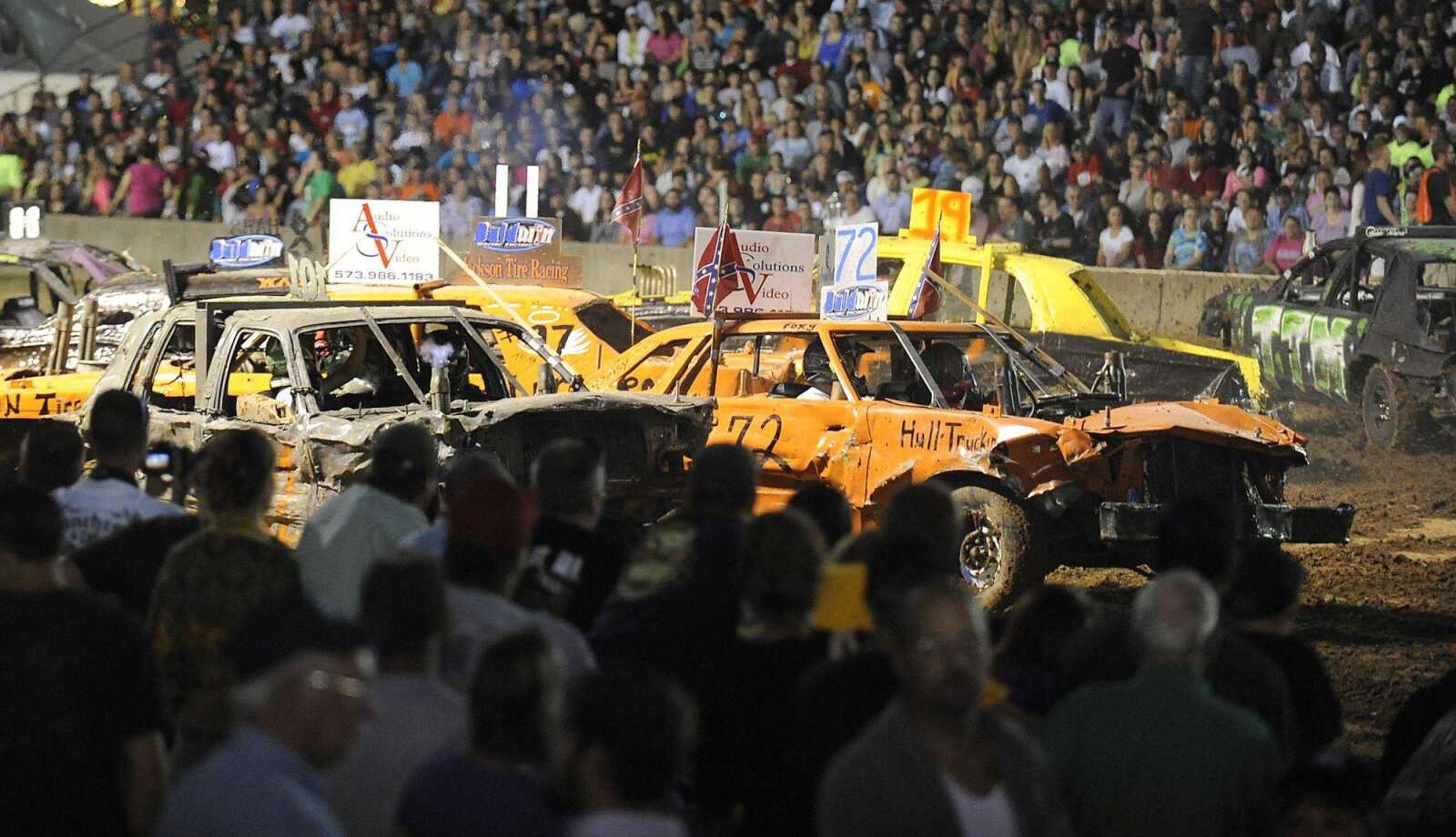 Spectators watch the demolition derby Tuesday at the SEMO District Fair at Arena Park in Cape Girardeau. (ADAM VOGLER)