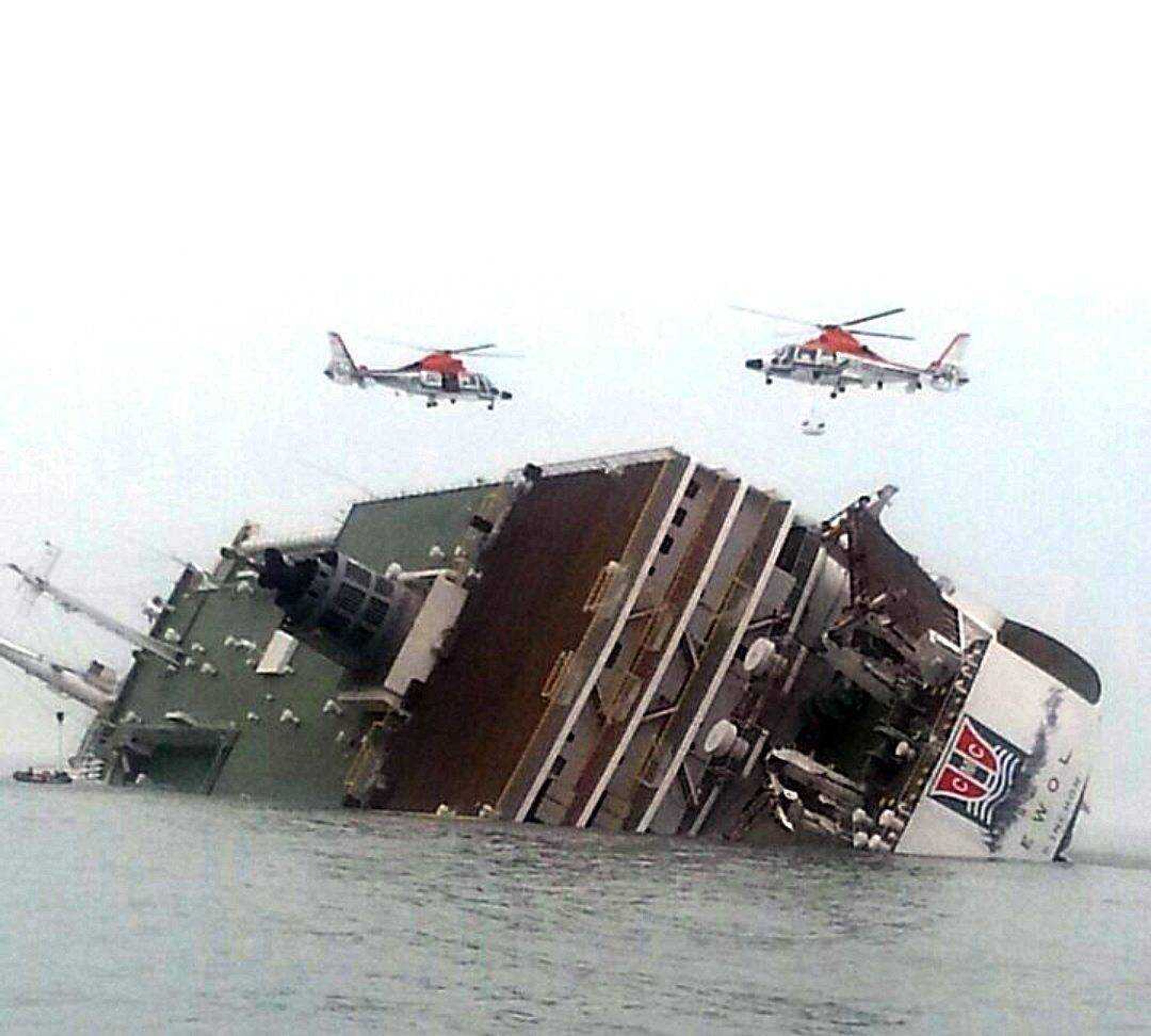 South Korean rescue helicopters fly over a South Korean passenger ship, trying to rescue about 470 passengers, in water off the southern coast in South Korea. (Yonhap ~ Associated Press)