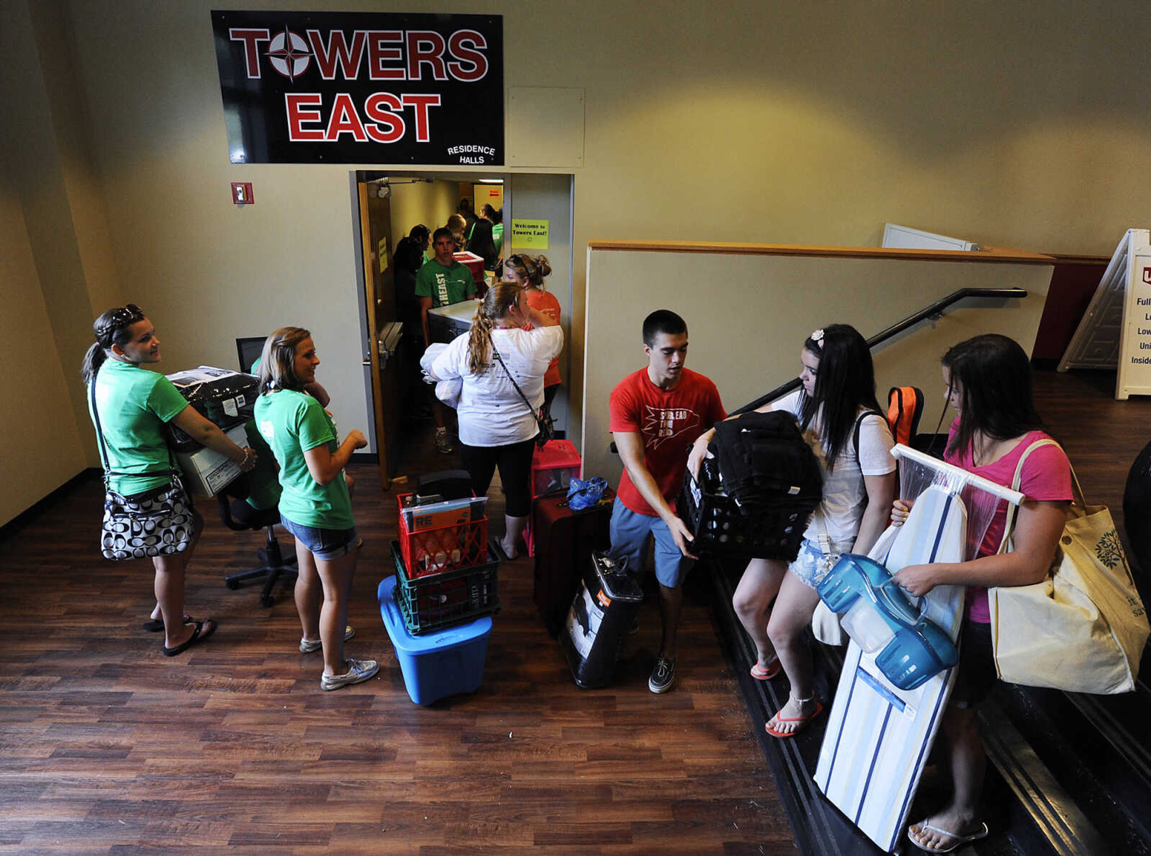 Incoming students and those helping them wait in line with their belongings at the Towers East residence halls during move in day Thursday, Aug. 22, at Southeast Missouri State University. Several campus organizations provided volunteers to help the approximately 1,100 students who moved into on-campus housing between 6 a.m and 1 p.m.