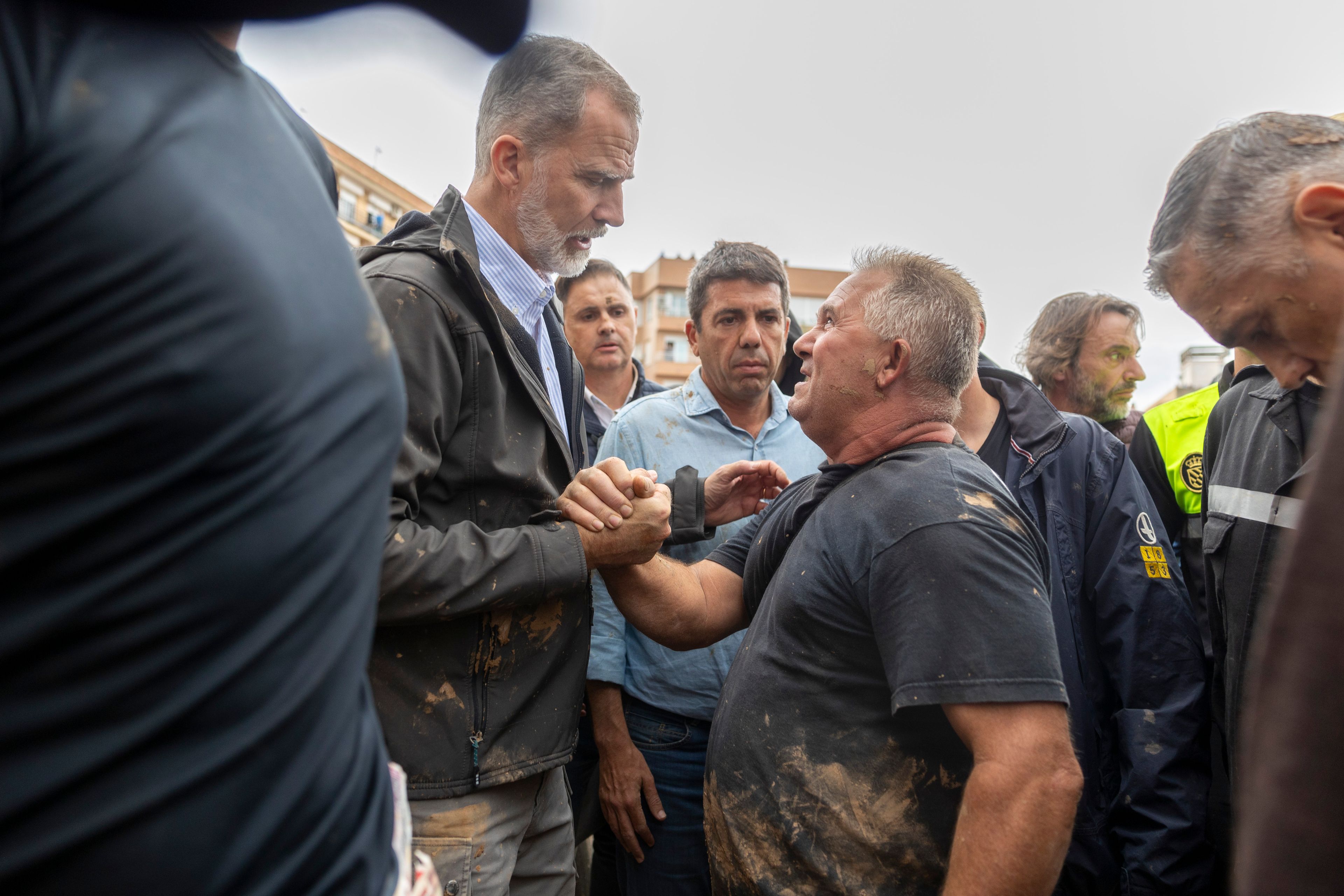 Spain's King Felipe VI speaks with people amidst angry Spanish flood survivors in Paiporta, near Valencia, Spain, Sunday Nov. 3, 2024. (AP Photo/David Melero)