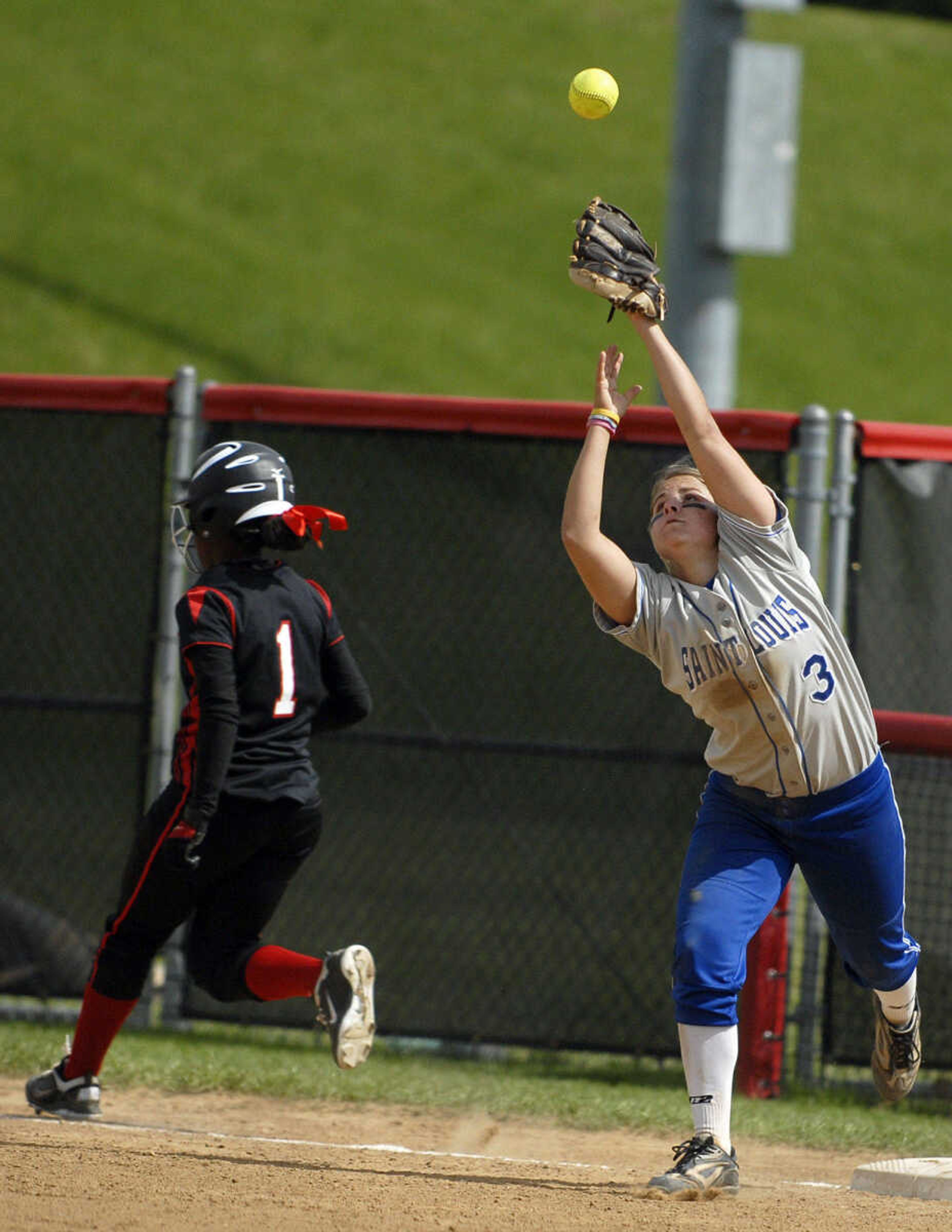 LAURA SIMON~lsimon@semissourian.com
Southeast base runner Evan Sallis is safe at first behind Saint Louis University's Kerri Dockins in the second inning of the first game of a double-header Wednesday, May 4, 2011 at the Southeast Softball Complex.