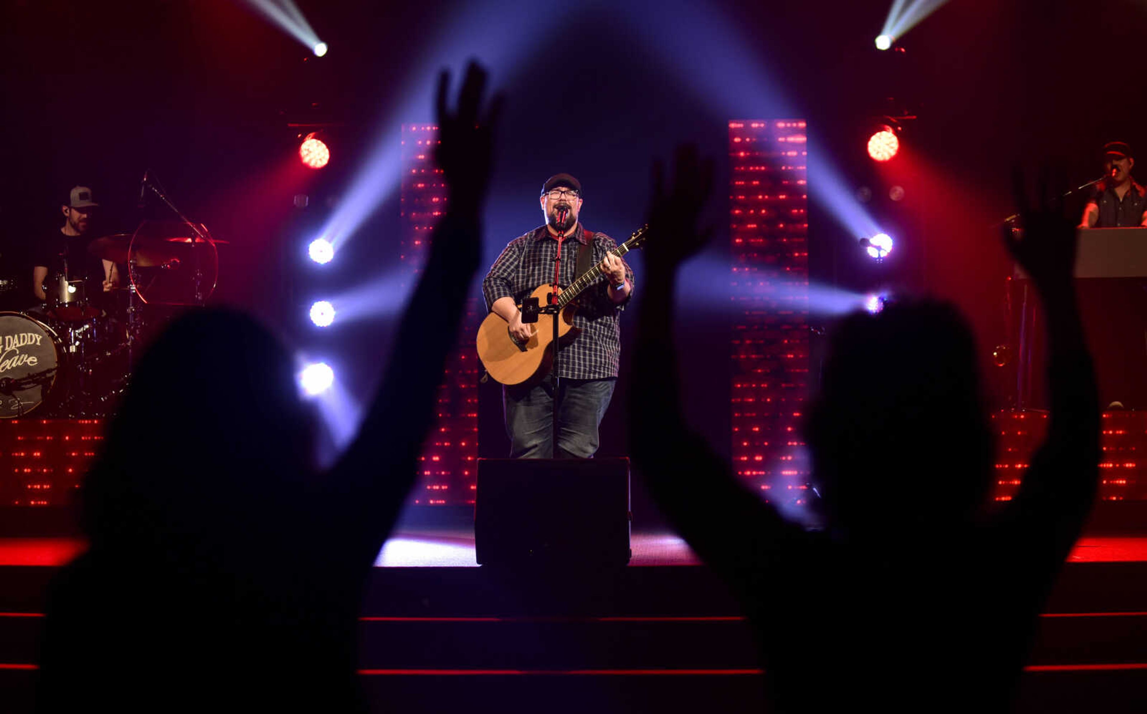 Tiffany Phillips, left, and Christy Walter, right, dance in the aisle as Mike Weaver performs during a Big Daddy Weave concert Wednesday, March 14, 2018, at Cape Bible Chapel in Cape Girardeau.