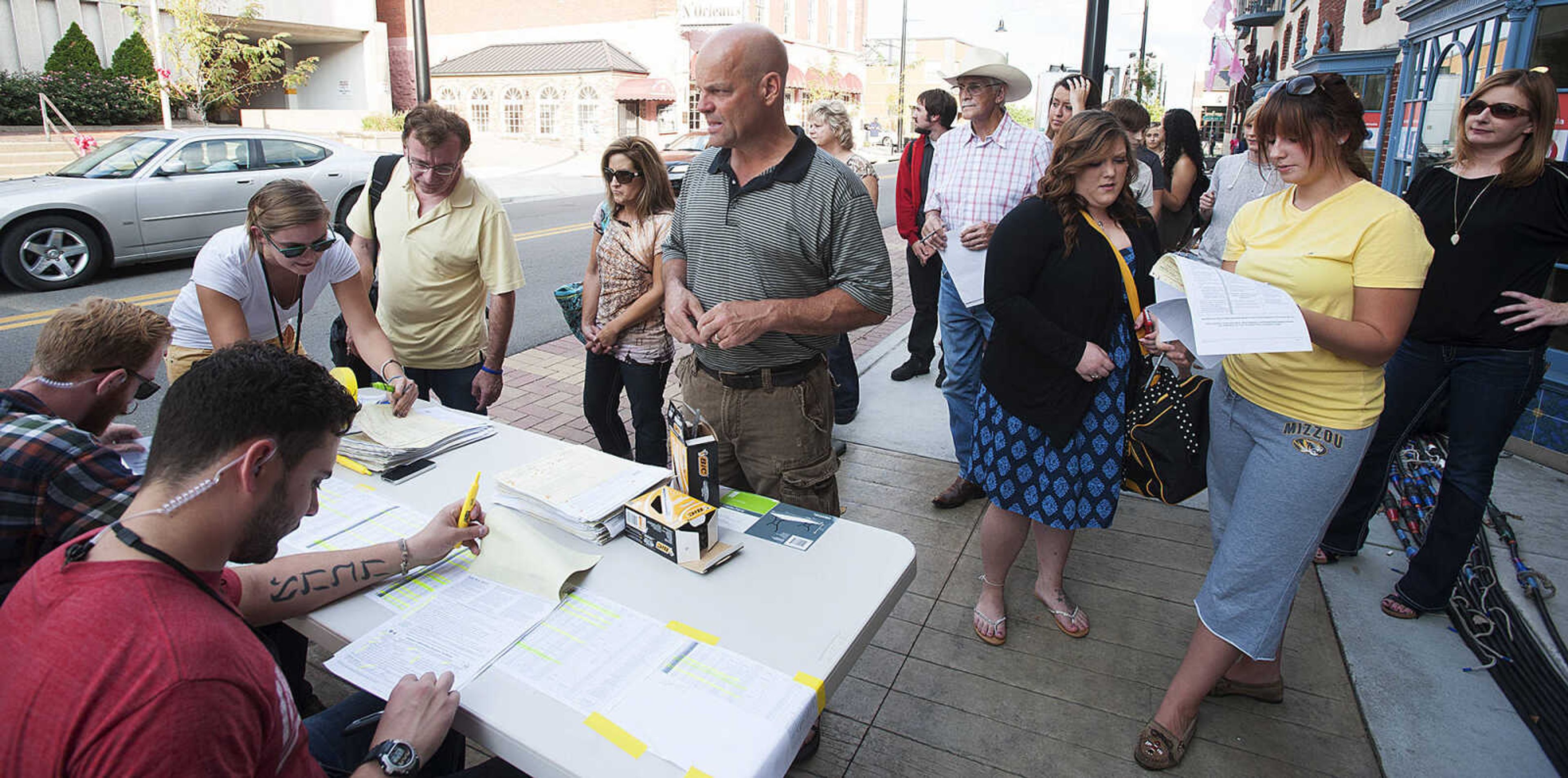 ADAM VOGLER ~ avogler@semissourian.com
Extras working on the 20th Century Fox feature film "Gone Girl," check in before filming a sceneThursday, Oct. 3, in downtown Cape Girardeau.