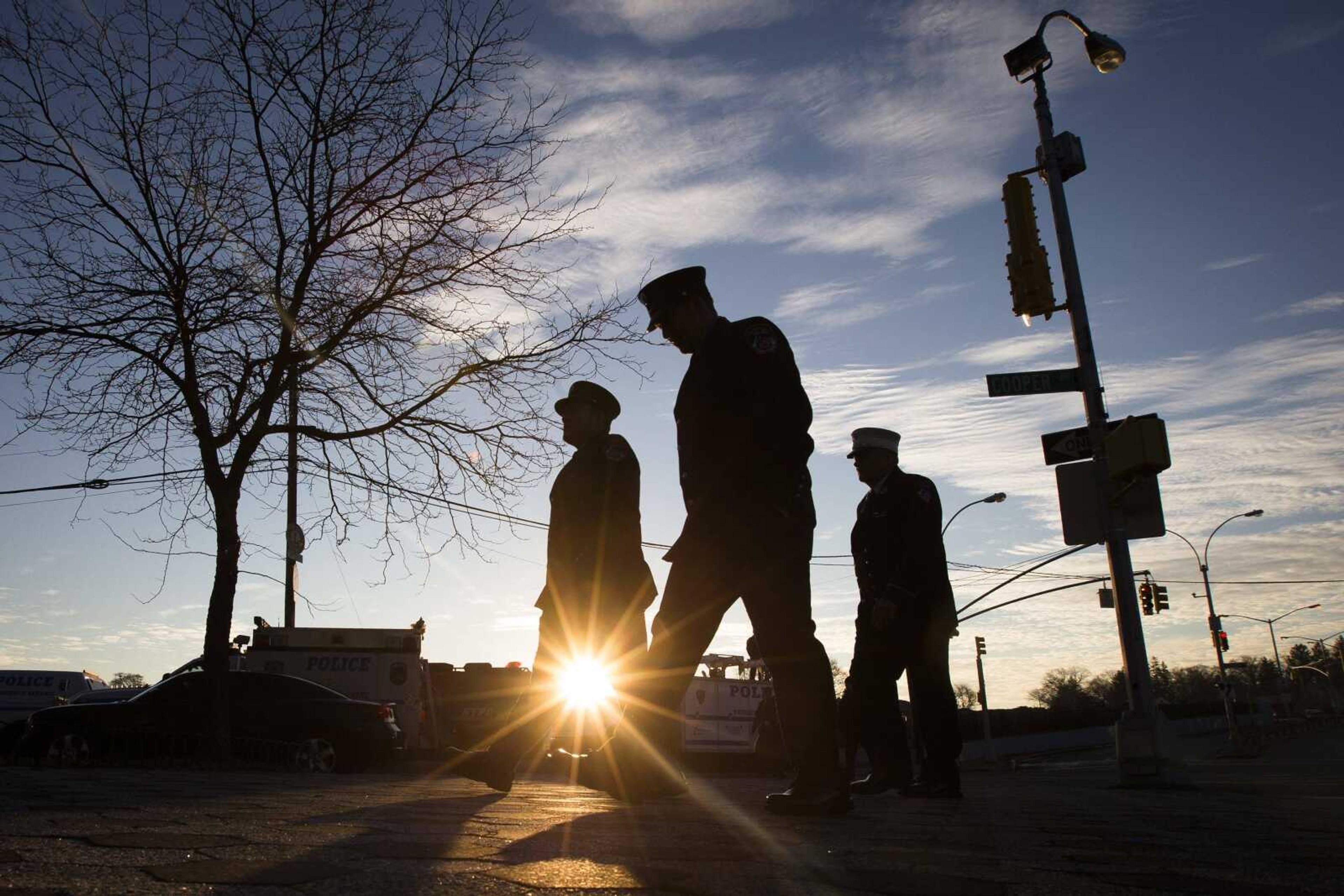 Firefighters arrive Saturday for the funeral of New York City police officer Rafael Ramos in the Glendale section of Queens in New York. Ramos and his partner, officer Wenjian Liu, were killed Dec. 20 as they sat in their patrol car on a Brooklyn street. The shooter, Ismaaiyl Brinsley, later killed himself. (John Minchillo ~ Associated Press)