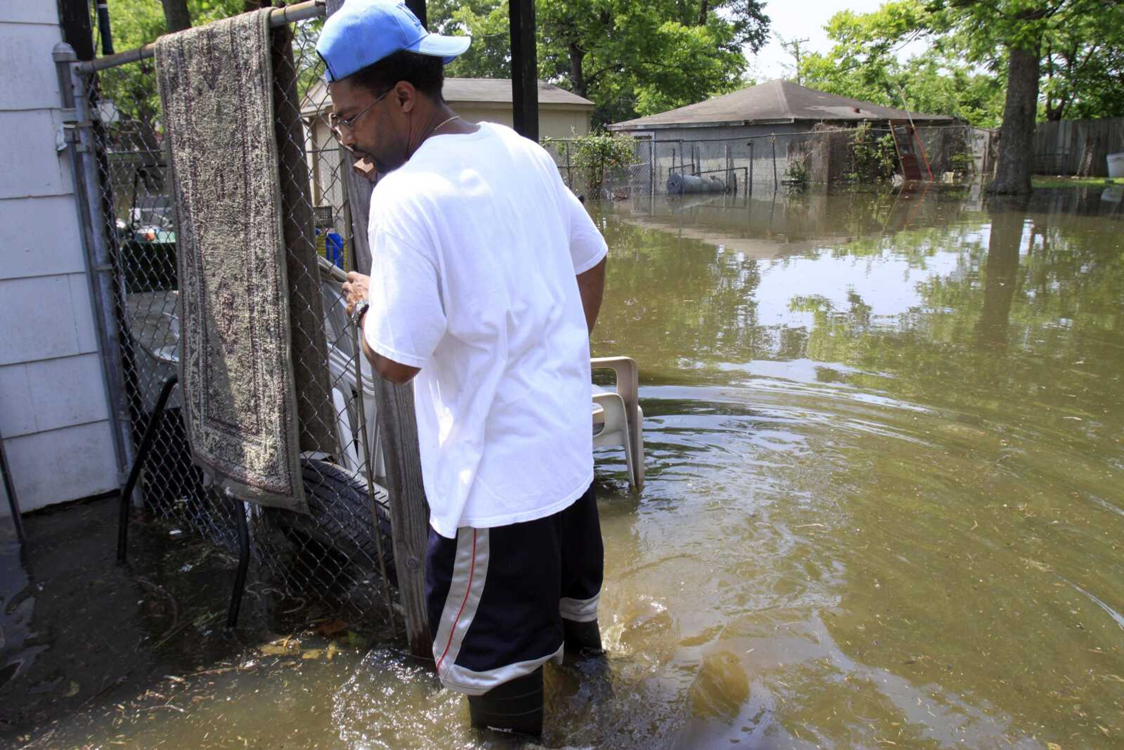 Gary Dugger walks in his flooded backyard Sunday, May 8, 2011, in Memphis, Tenn. Dugger was hoping to wait out the flood in his home but rising water has forced him to flee for higher ground as the mighty Mississippi River edged toward the city, threatening to bring more flooding to parts of an area already soaked. (AP Photo/Jeff Roberson)