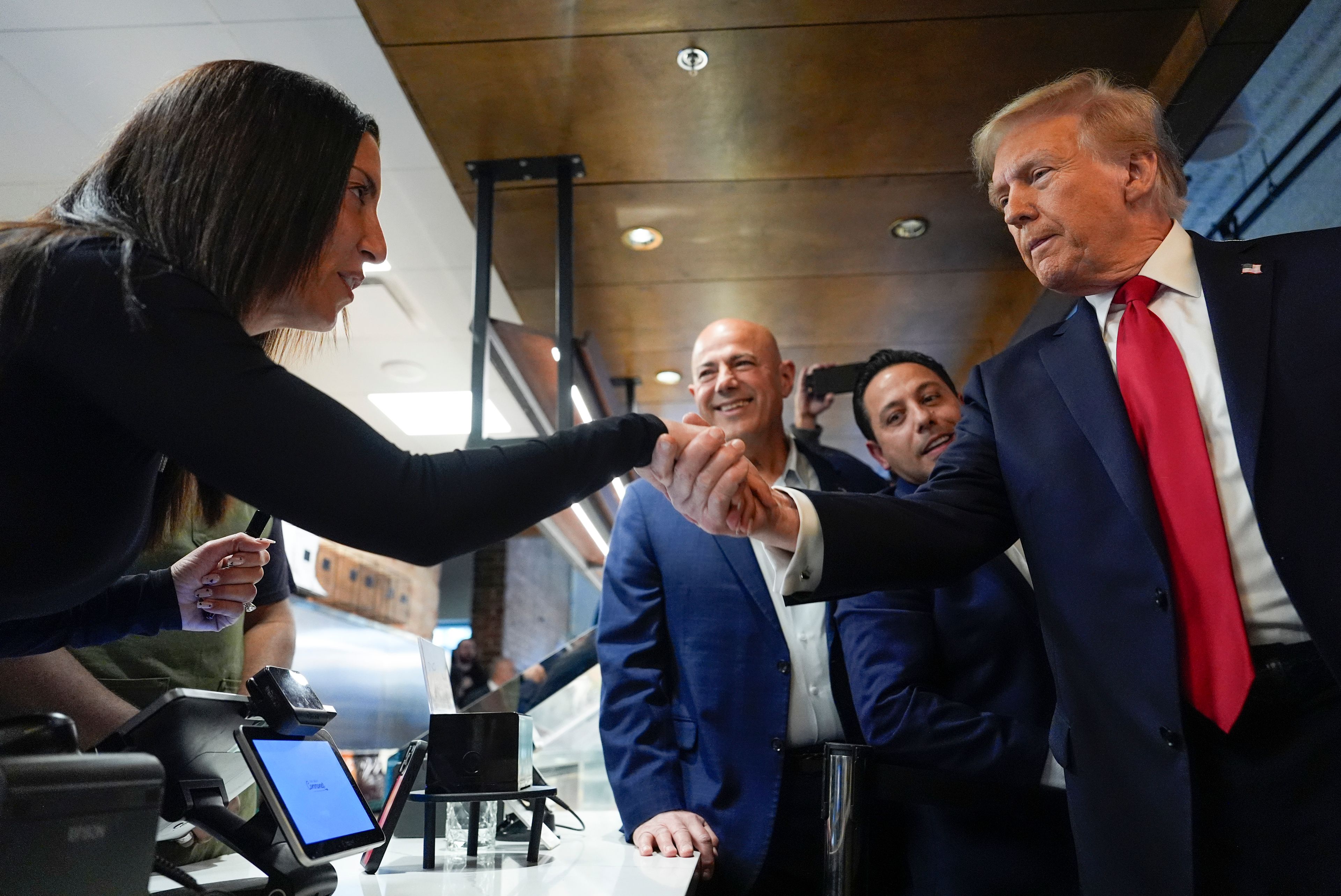 Republican presidential nominee former President Donald Trump greets people as he visits The Great Commoner, Friday, Nov. 1, 2024, in Dearborn, Mich. (AP Photo/Julia Demaree Nikhinson)