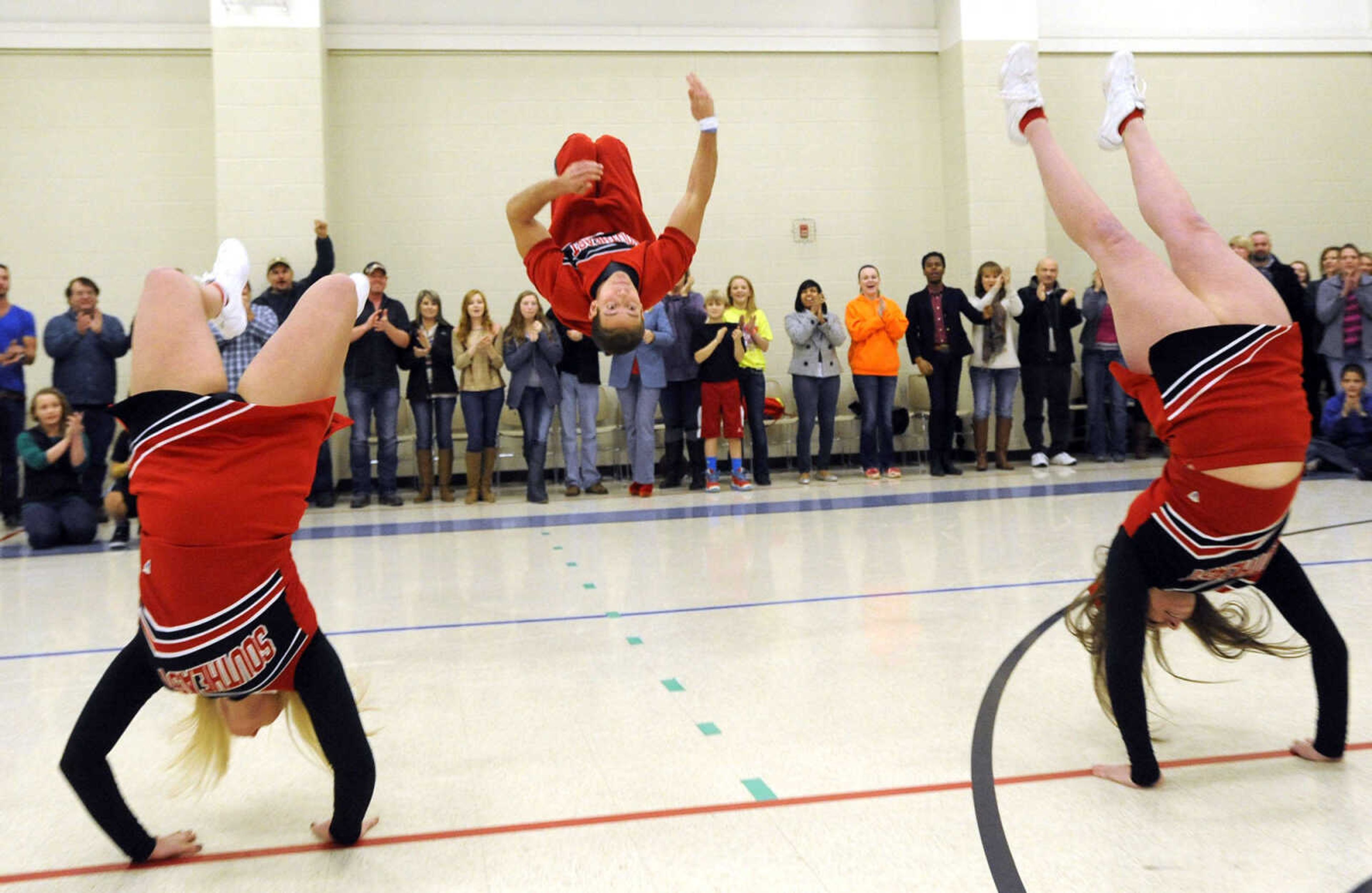 Cheerleaders perform to the applause of extras while filming the movie, "Love Chronicles (of the Cape) on Sunday, Jan. 11, 2015 at Shawnee Park Center in Cape Girardeau.