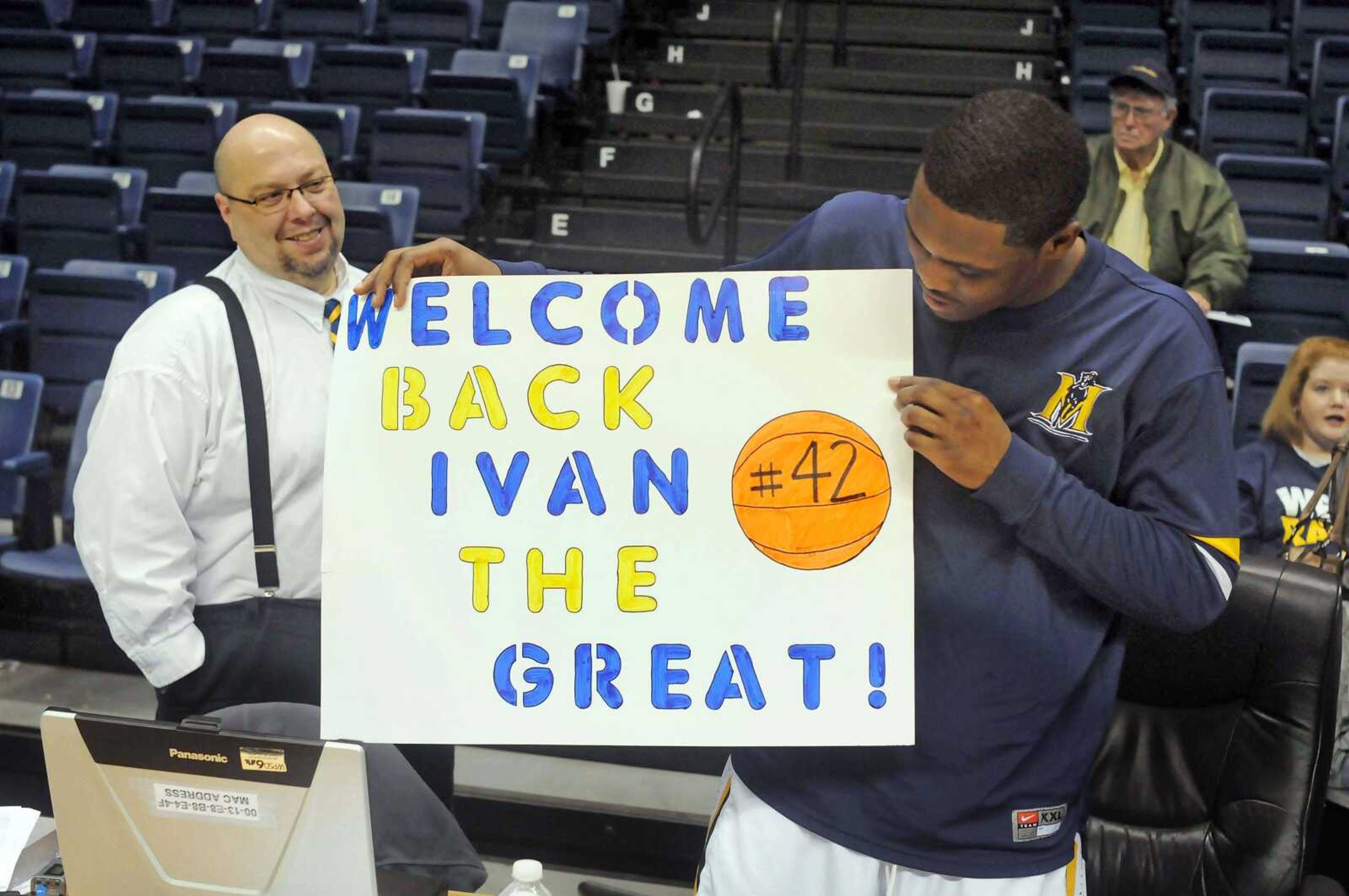 Murray State's Ivan Aska, right, displays a sign he received from a fan after an NCAA college basketball game against Eastern Illinois, Saturday, Jan. 28, 2012, in Murray, Ky. At left is radio broadcaster Neal Bradley. Murray State won 73-58. (AP Photo/The Paducah Sun, John Wright)