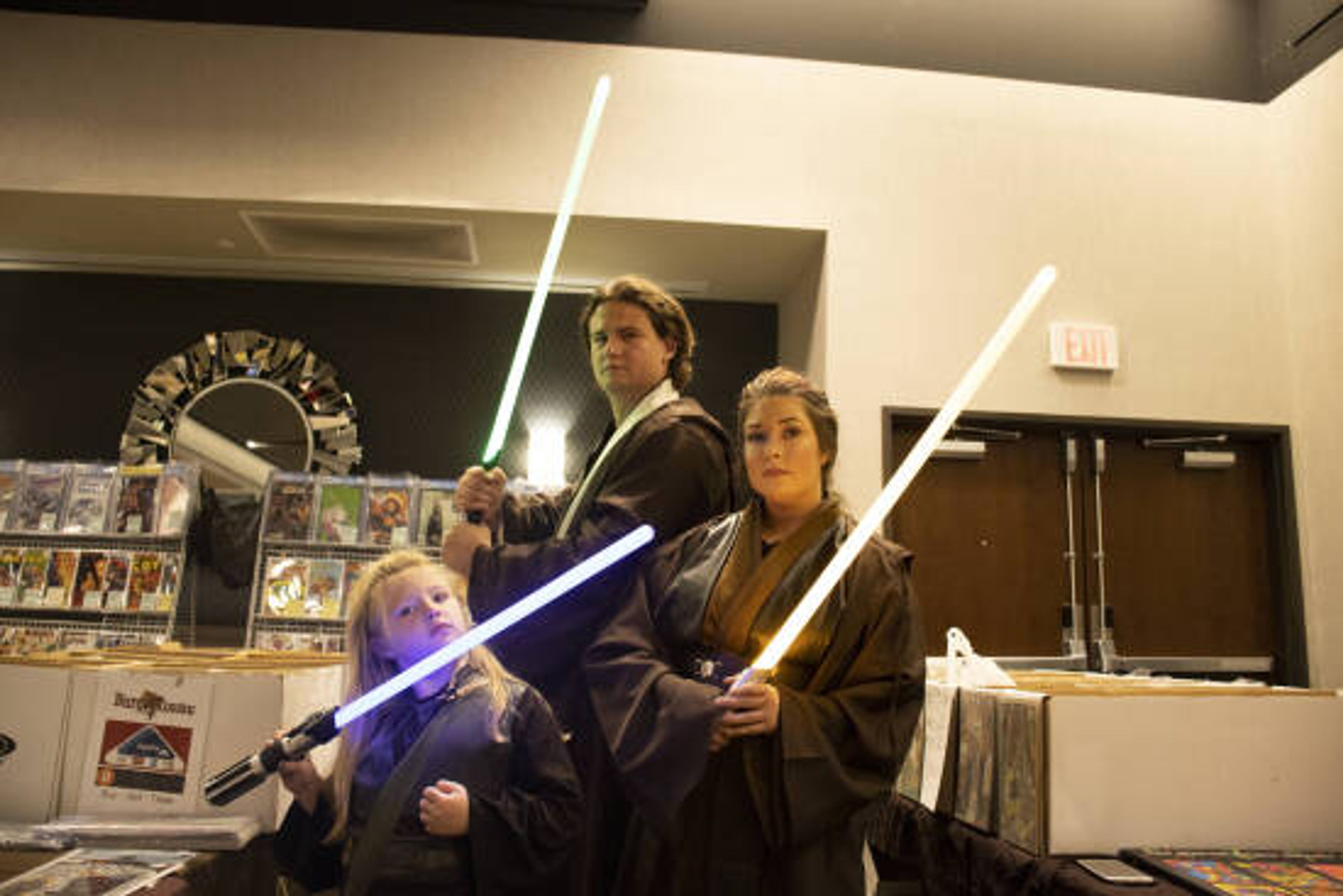 Payton Foltz, Brady Perkins and Lydia Reitzel walk around the conference center dressed up as Jedi from the film Star Wars on Oct. 2, 2022.