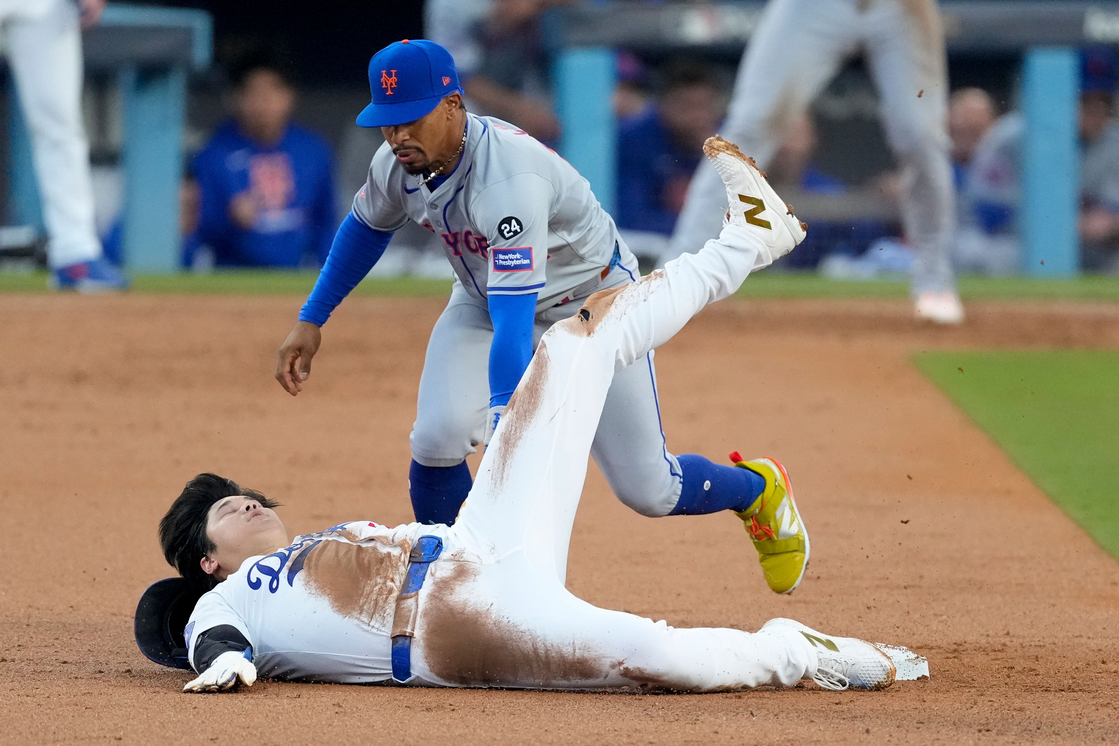 Los Angeles Dodgers' Shohei Ohtani steals second base past New York Mets shortstop Francisco Lindor during the second inning in Game 1 of a baseball NL Championship Series, Sunday, Oct. 13, 2024, in Los Angeles. (AP Photo/Mark J. Terrill)