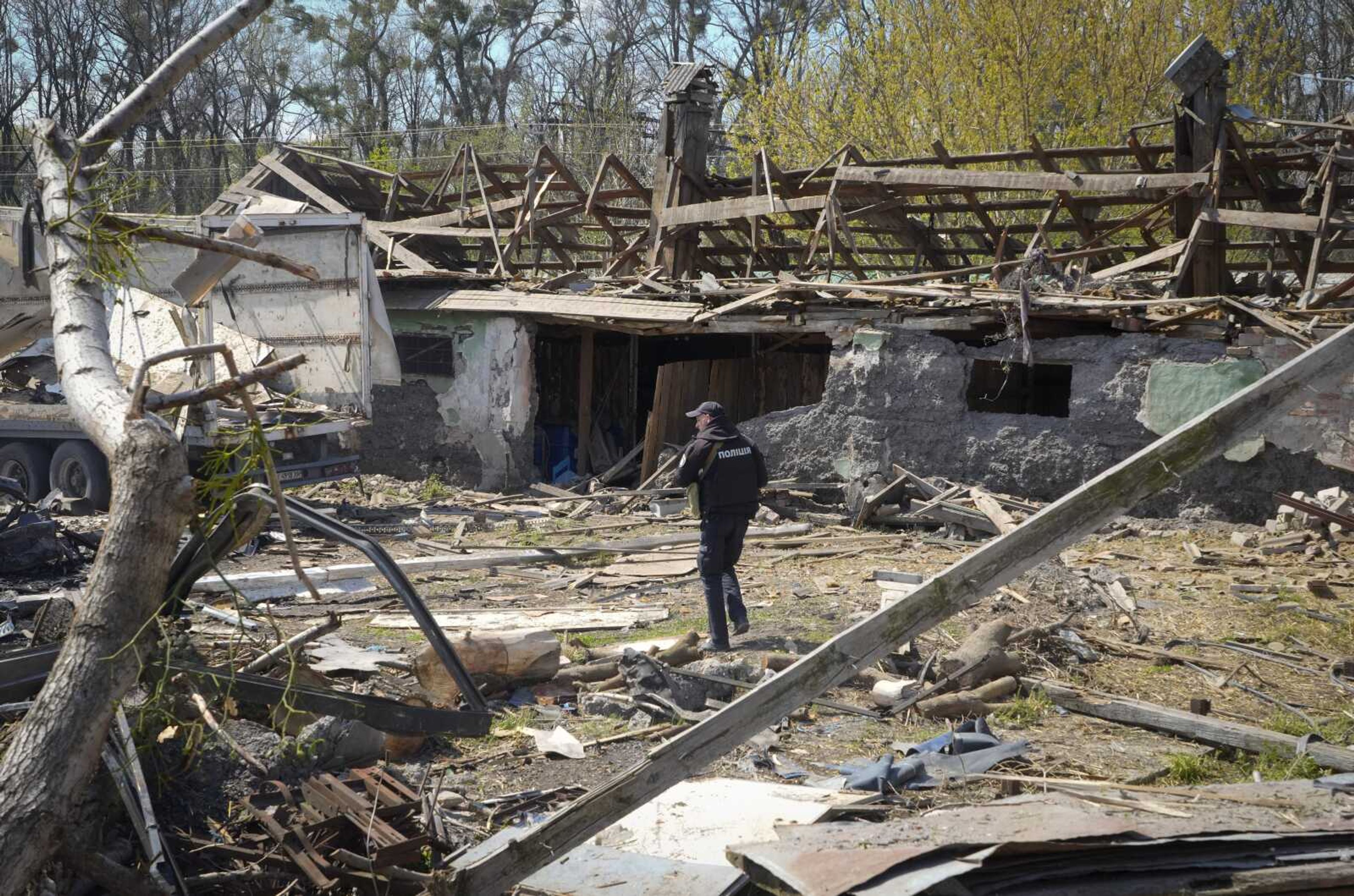 A police officer inspects a destroyed area following a Russian missiles attack on Thursday in Fastov, south of Kyiv, Ukraine, Friday, April 29, 2022. (AP Photo/Efrem Lukatsky)