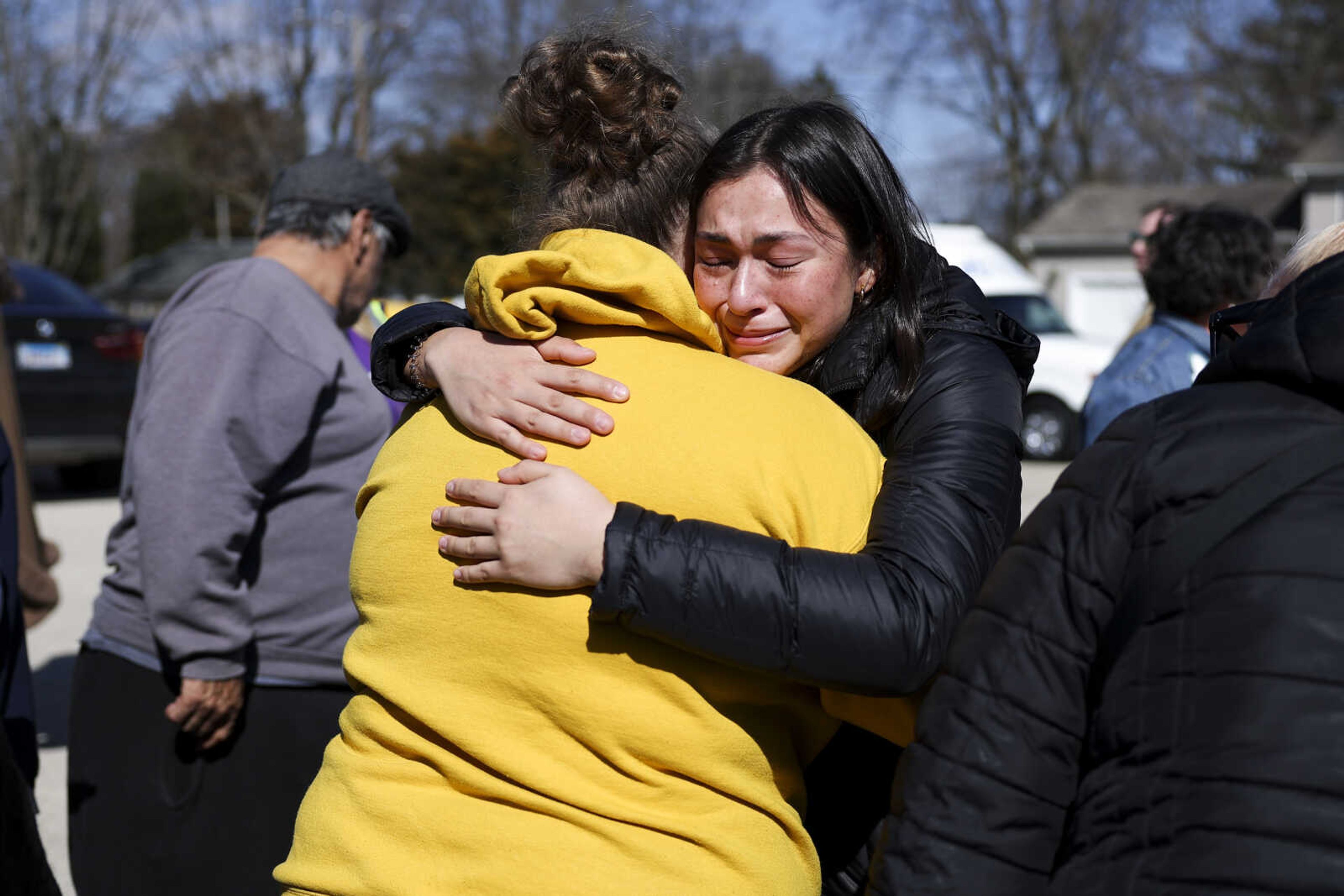 Bella Rosado, right, and Delanie Palmer, friends of stabbing victim Jenna Newcomb, hug during a vigil Thursday, March 28, 2024, in Rockford, Ill., for the victims of Wednesday's stabbings. (Eileen T. Meslar/Chicago Tribune via AP)