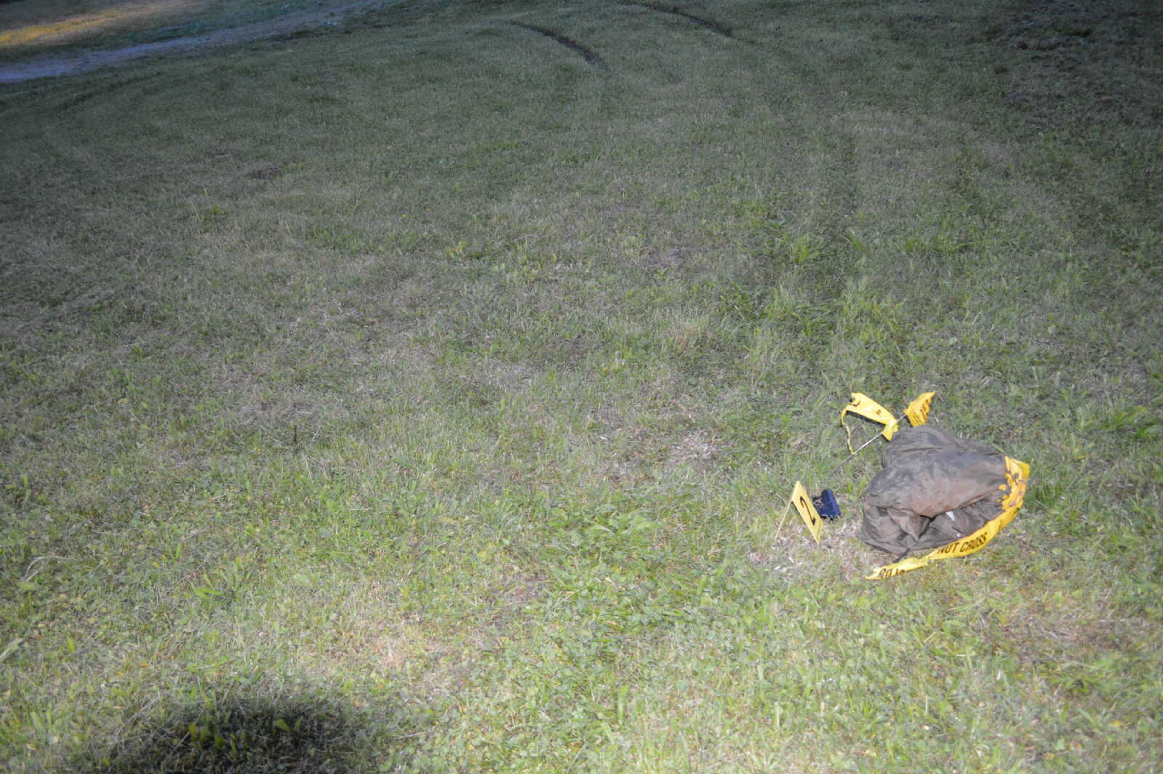 Jason McBride's backup Ruger handgun, which was previously secured around his ankle, and was found alongside the tire marks left in the grass, according to police evidence.