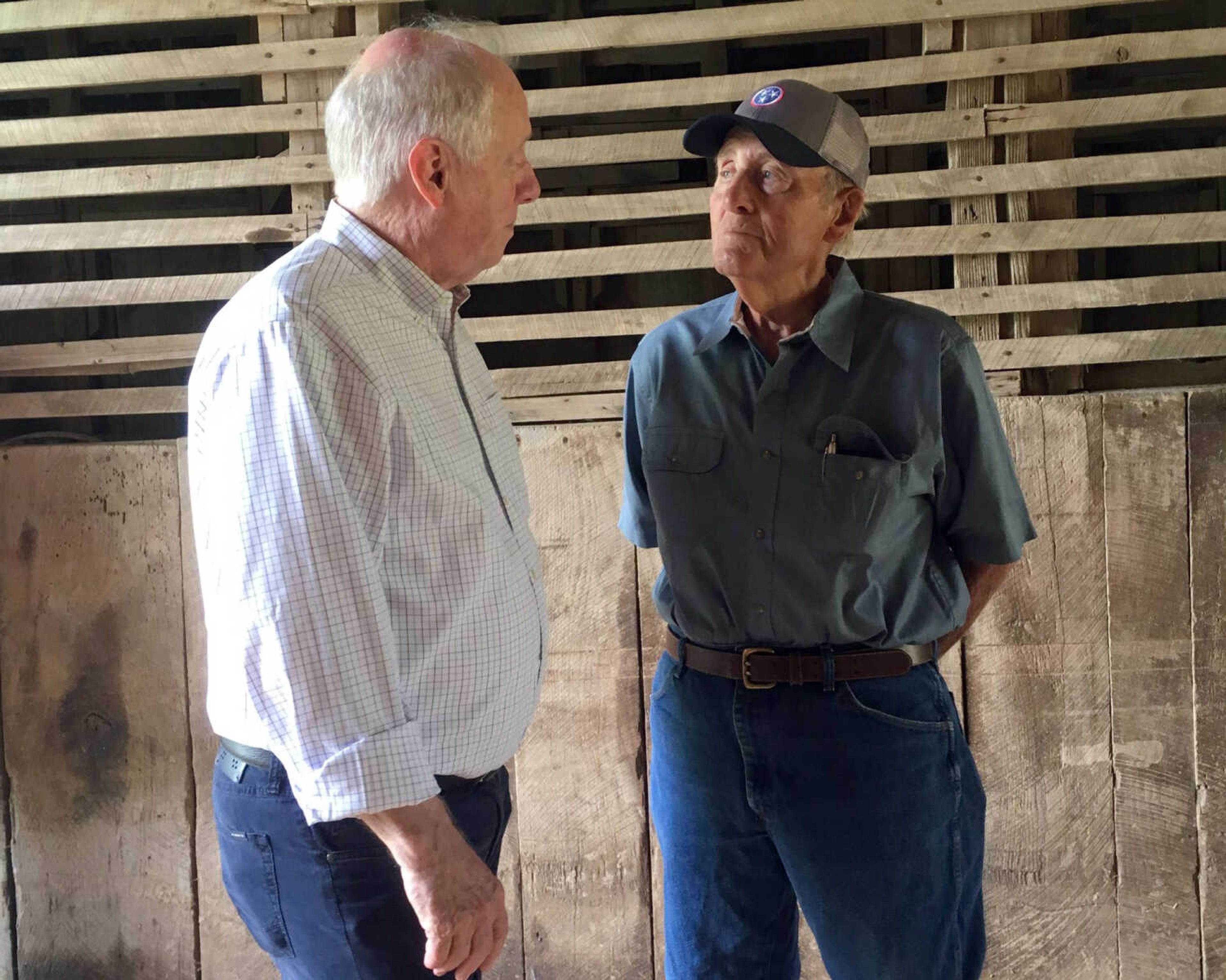 Democratic U.S. Senate candidate and former Gov. Phil Bredesen, left, talks with David Womack, a farmer and former American Soybean Development Foundation president, on June 14 during a visit to Farrar Farm in Flat Creek, Tennessee.