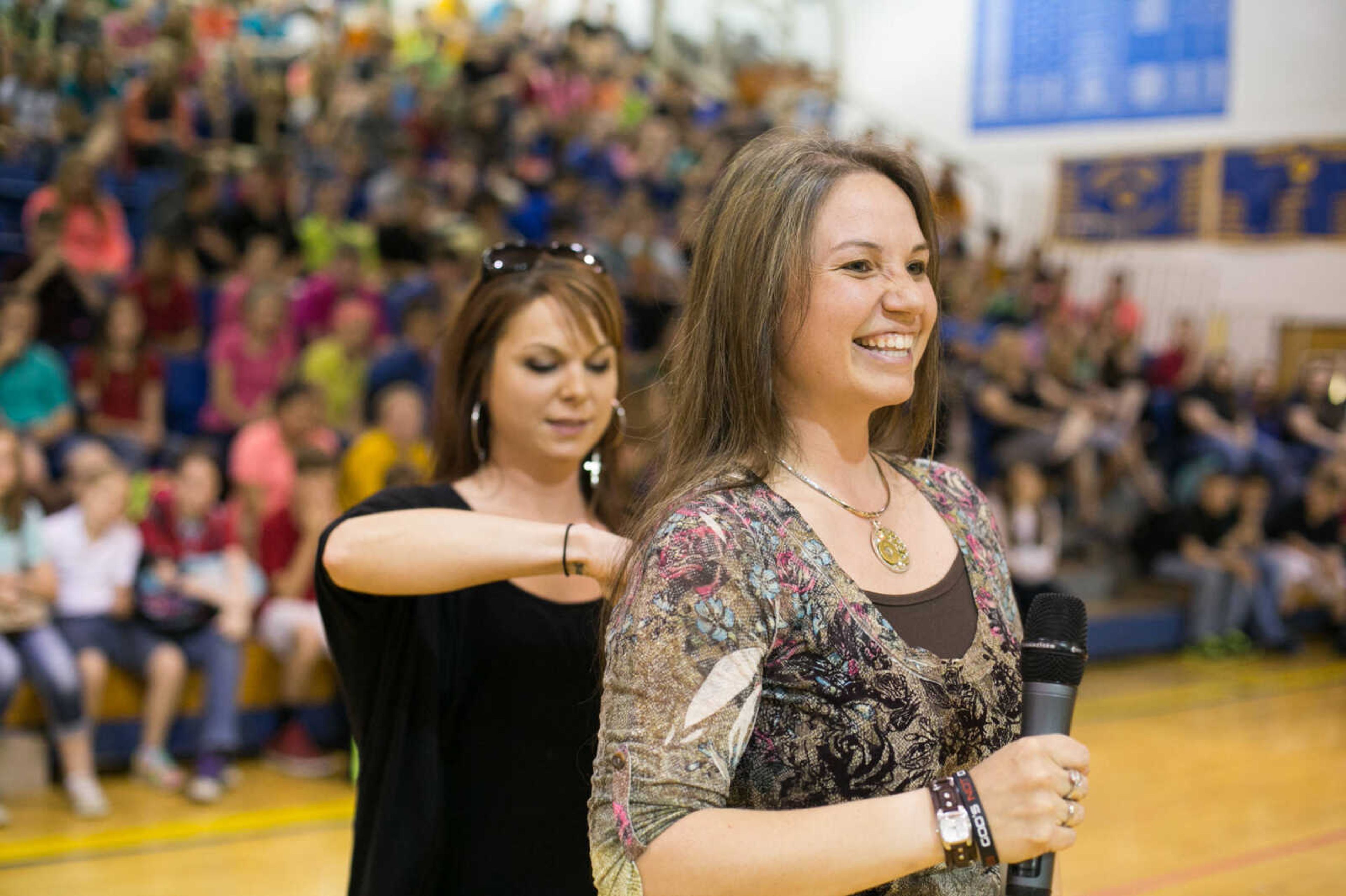 GLENN LANDBERG ~ glandberg@semissourian.com

Sara Bradshaw, a middle-school teacher in Scott City, has her hair cut and donated to the Beautiful Lengths program Monday, May 18, 2015 at Scott City High School. Twenty-four students and teachers participated in the event that provides wigs to cancer patients across the country.