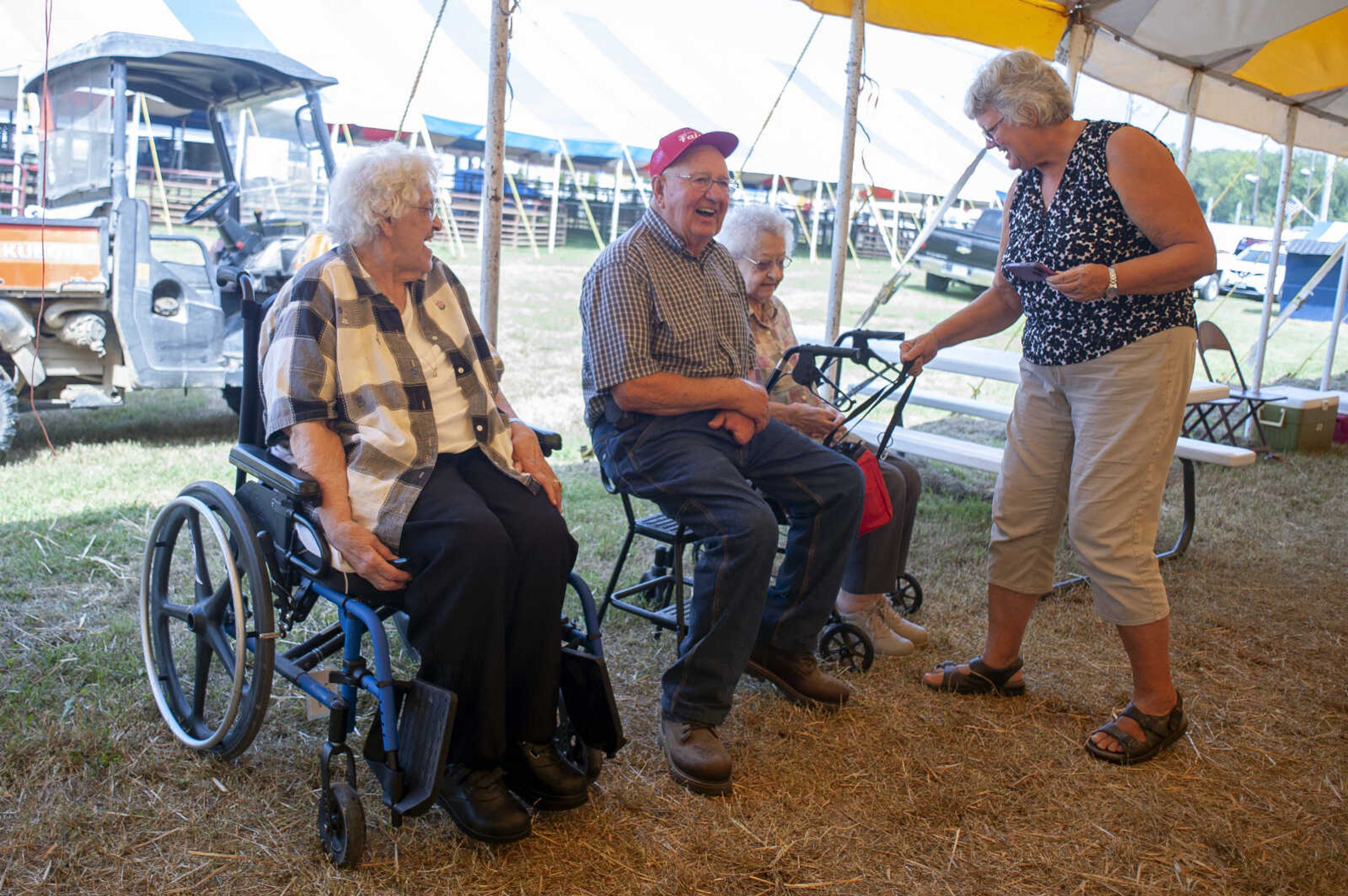 Siblings from left: Adella Frank, Joe Kirchdoerfer and Marie James get ready to have photos taken as Joe's niece Liz Aufdenberg, standing, helps them get ready for photos during the 2019 SEMO District Fair on Monday, Sept. 9, 2019, at Arena Park in Cape Girardeau.