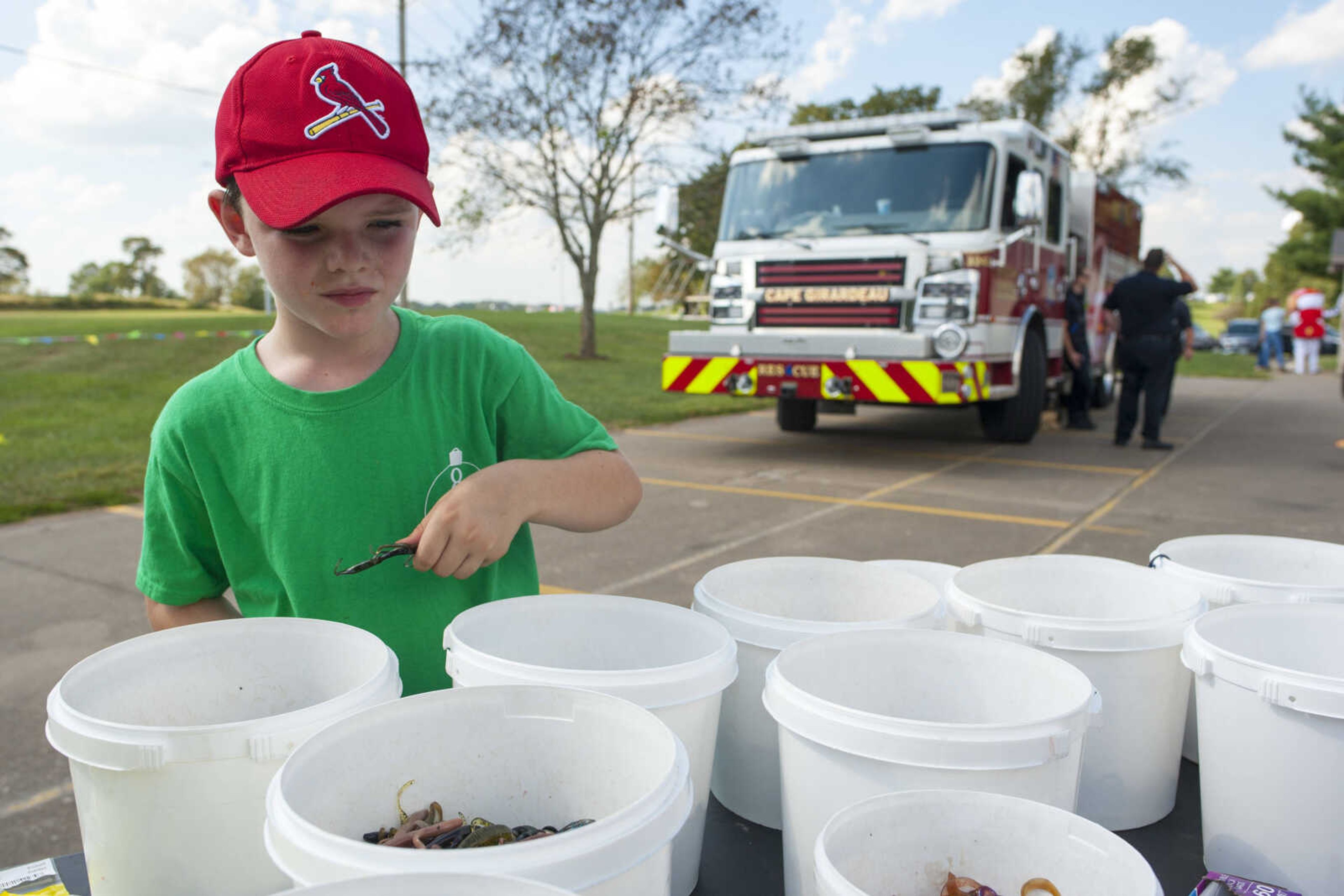 Caden Dillingham, 8, of Cape Girardeau, fills a bag with fishing lures at Big Nate's Bait and Tackle stand Sept. 29, 2019, at Cape County Park North. At a price of $1.50, the stand offered children as many fishing lures as they could fit into a sandwich bag.