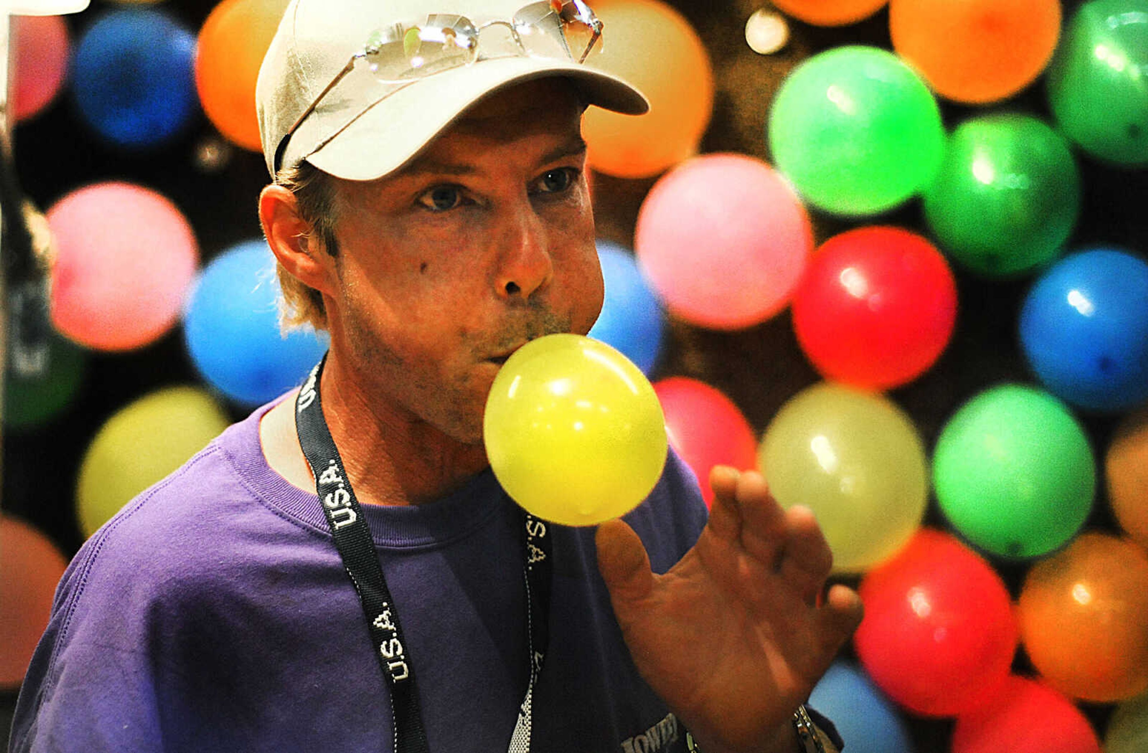 LAURA SIMON ~ lsimon@semissourian.com

John Elst blows up balloons to replace popped ones at the Bust-1-U-Win game at the SEMO District Fair, Wednesday, Sept. 10, 2014.