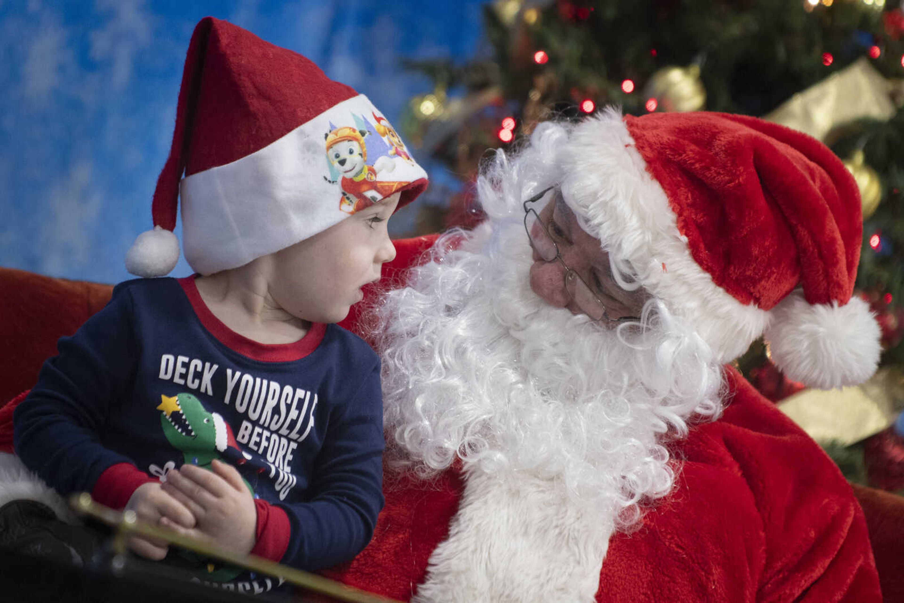 Ian Ryan, 2, of Jackson meets with Santa Claus, portrayed by City of Cape Girardeau Parks &amp; Recreation parks division manager Brock Davis, during the Cape Parks &amp; Recreation Foundation's Breakfast with Santa event Saturday, Dec. 14, 2019, at the Osage Centre in Cape Girardeau.