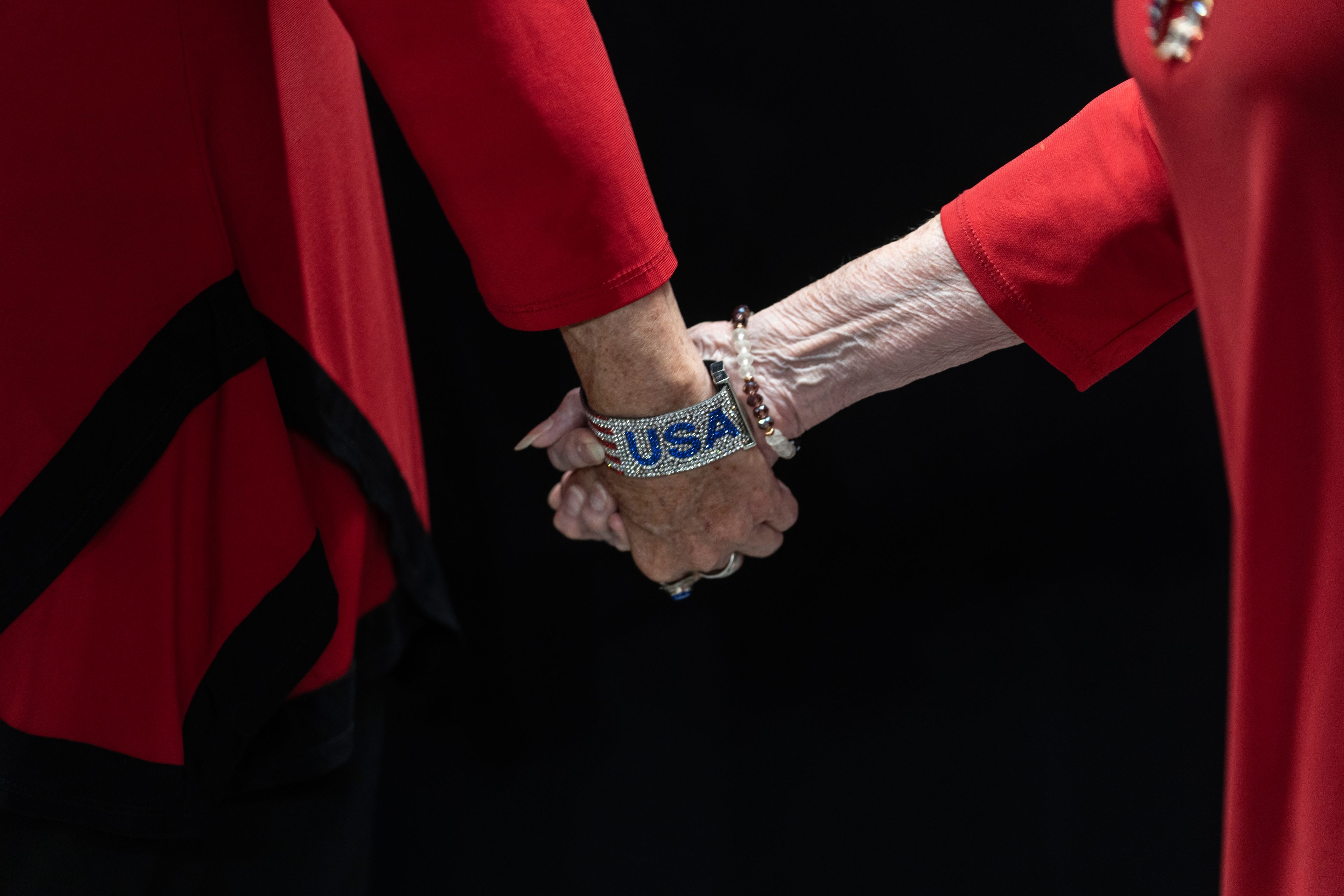 Supporters of Republican presidential nominee former President Donald Trump walk holding hands while arriving to a campaign rally at the Findlay Toyota Arena, Sunday, Oct. 13, 2024, in Prescott Valley, Ariz. (AP Photo/Rodrigo Abd)