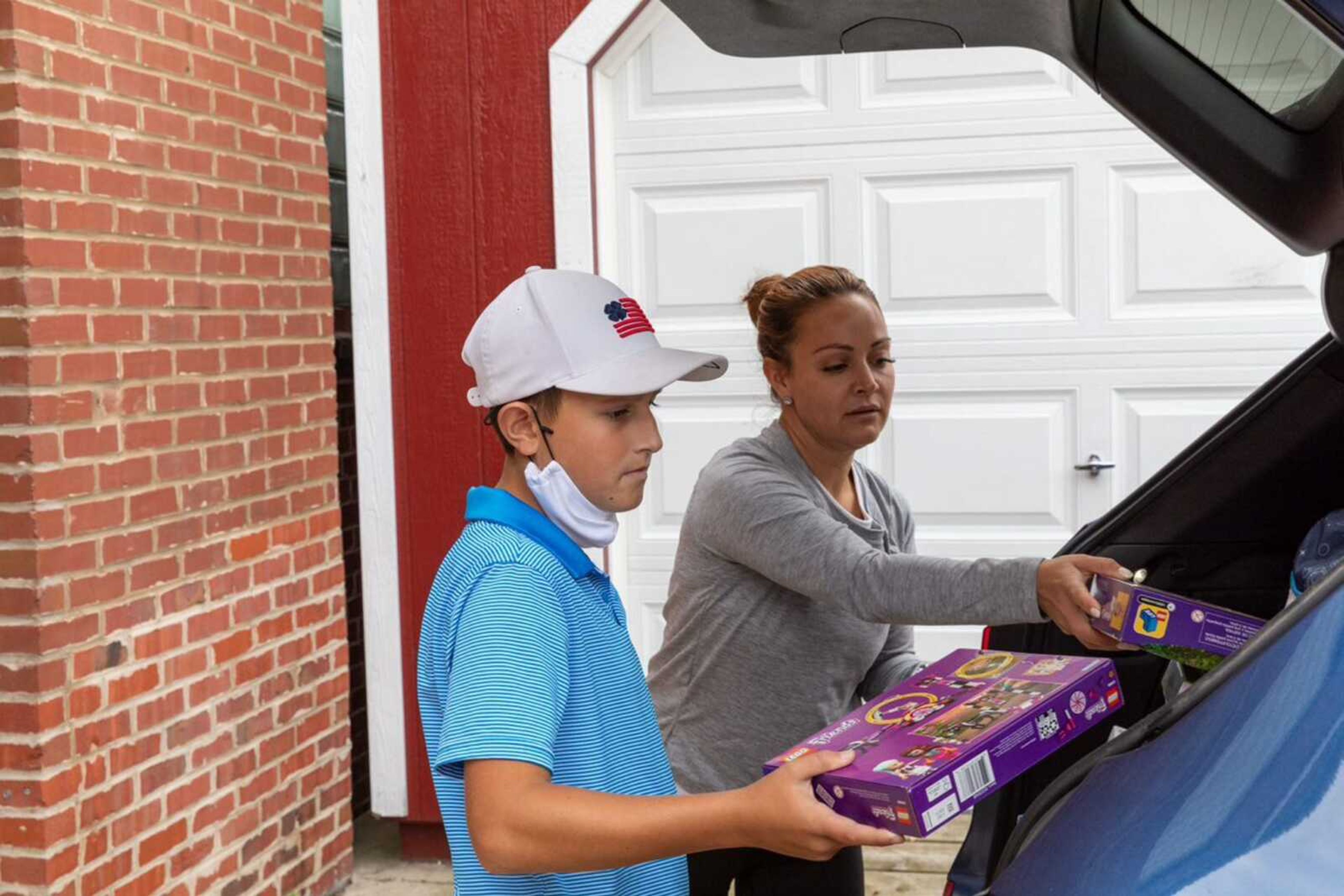 Jimmy Williams and his mother, Shana Williams, unload their car full of toy donations.