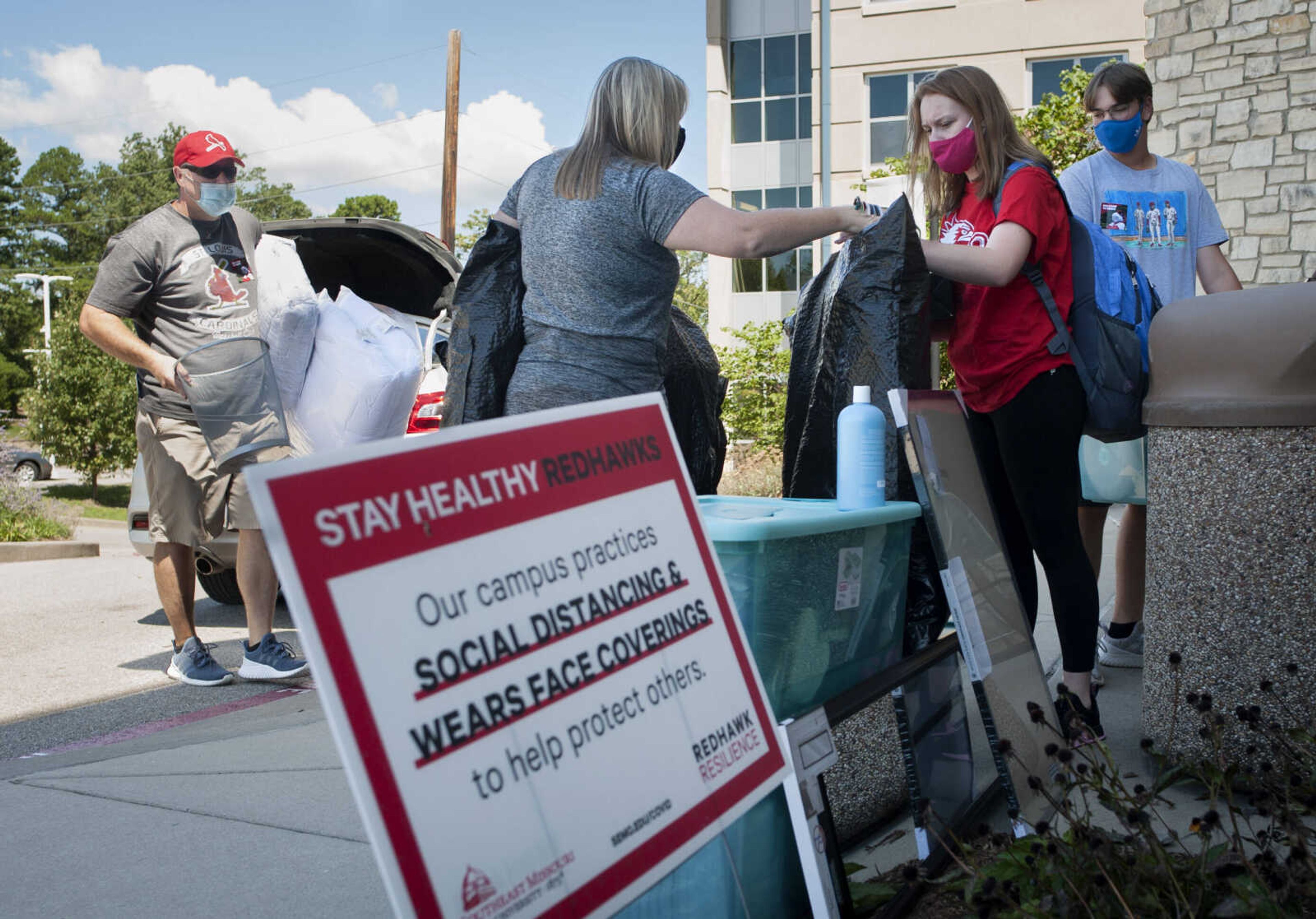 Alyx Steward, center right, moves into Laferla Hall with help from her parents, Steve Steward and Tanya Hovis, and 16-year-old brother Eric Steward on Wednesday, Aug. 19, 2020, at Southeast Missouri State University in Cape Girardeau.