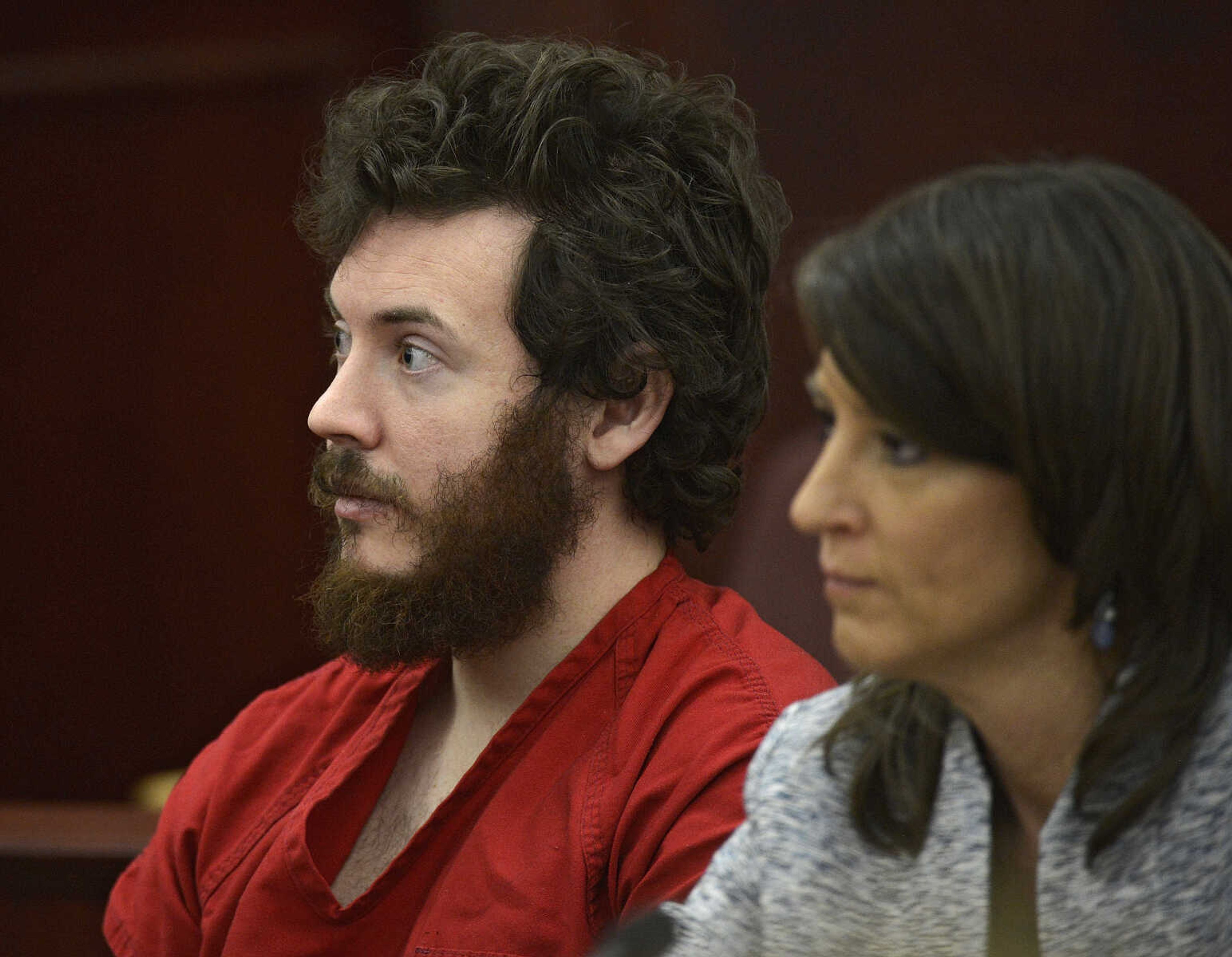 FILE - In this March 12, 2013 file photo, James Holmes, left, and defense attorney Tamara Brady appear in district court in Centennial, Colo. for his arraignment. Prosecutors say they are not are ready to accept an offer from Colorado theater shooting suspect James Holmes to plead guilty in exchange for avoiding the death penalty. In a court filing Thursday, March 28, 2013 prosecutors criticized defense attorneys for publicizing Holmes' offer to plead guilty. (AP Photo/The Denver Post, RJ Sangosti, Pool, File)