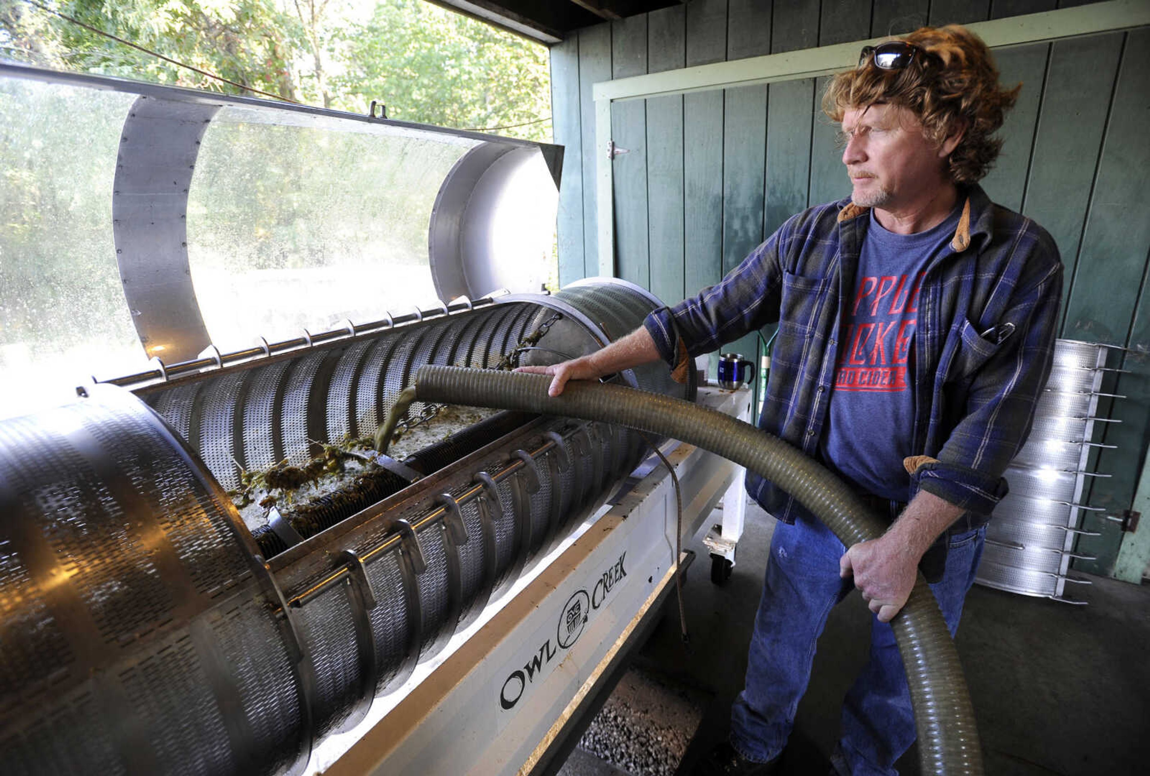 FRED LYNCH ~ flynch@semissourian.com
Brad Genung loads the grape must into the presser at Owl Creek Vineyard.