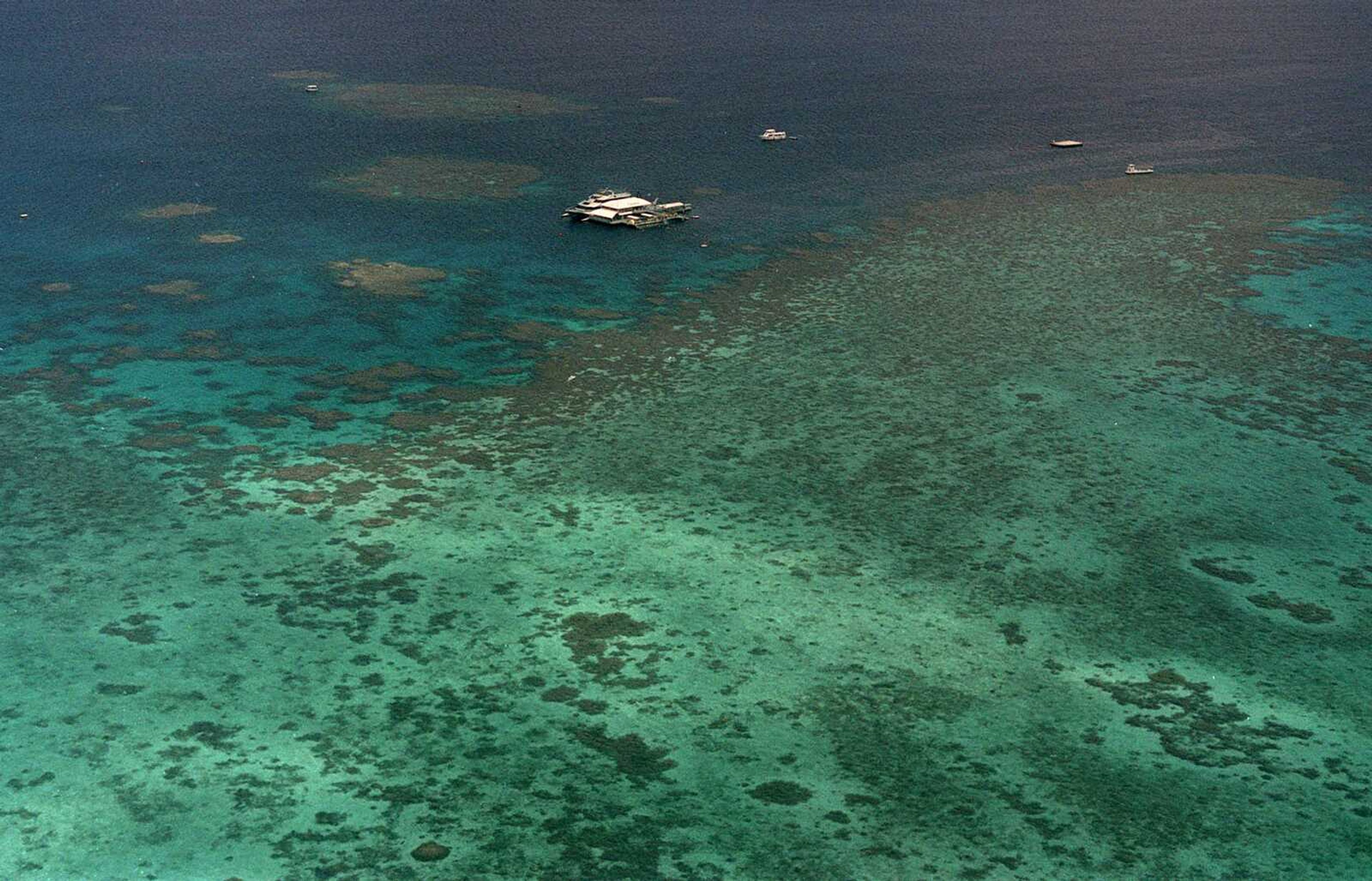 FILE - This Sept. 10, 2001, file photo shows Agincourt Reef, located about 30 miles off the coast near the northern reaches of the 1,200-mile long Great Barrier Reef. The Great Barrier Reef is facing a critical period of heat stress over the coming weeks following the most widespread coral bleaching the natural wonder has ever endured, scientists said Friday, March 6, 2020.(AP Photo/Randy Bergman, File)