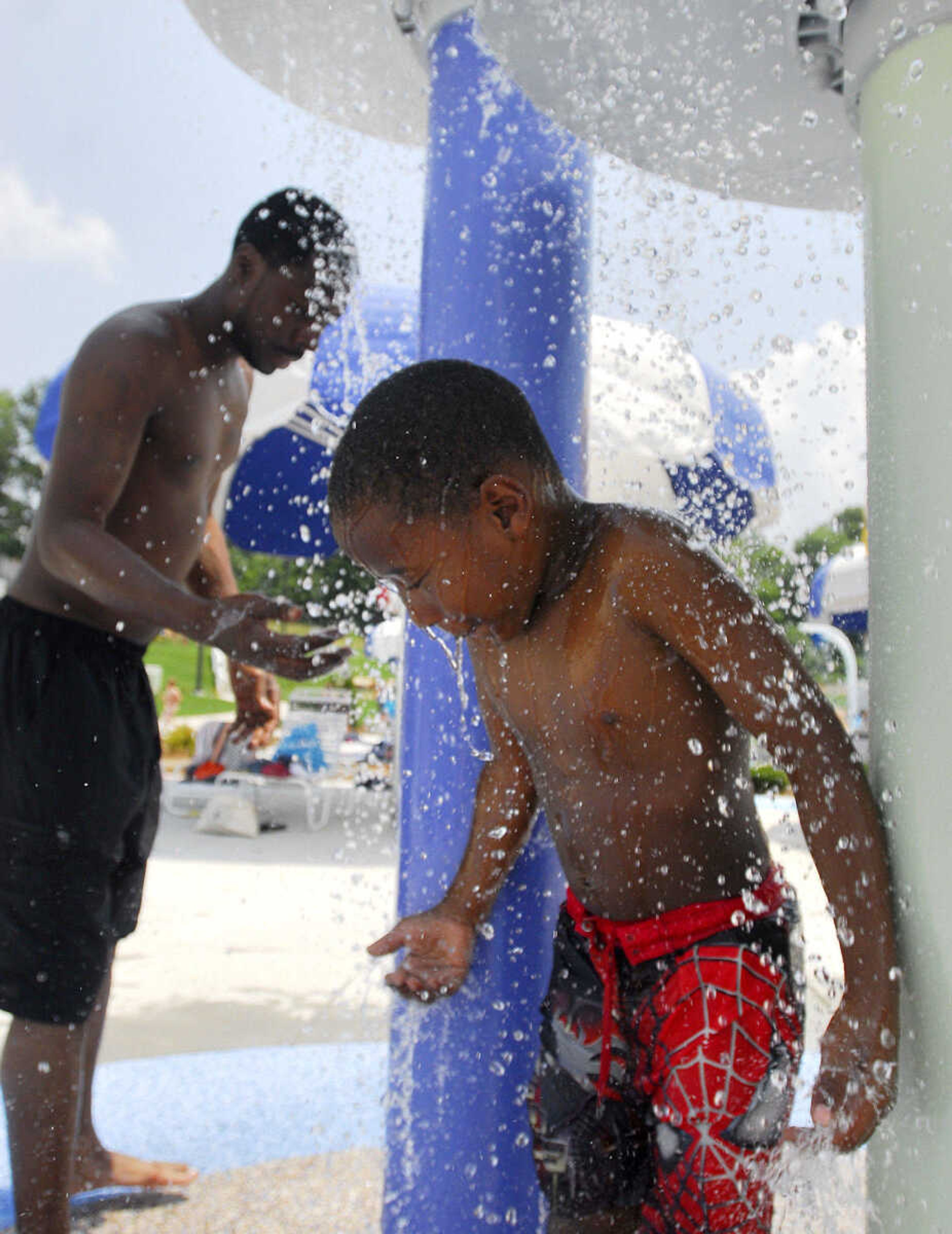 LAURA SIMON~lsimon@semissourian.com
James Hamilton, 6, stands under the water towers on the splash pad area  Saturday, May 29, 2010 during the opening day of Cape Splash Family Auquatic Center.