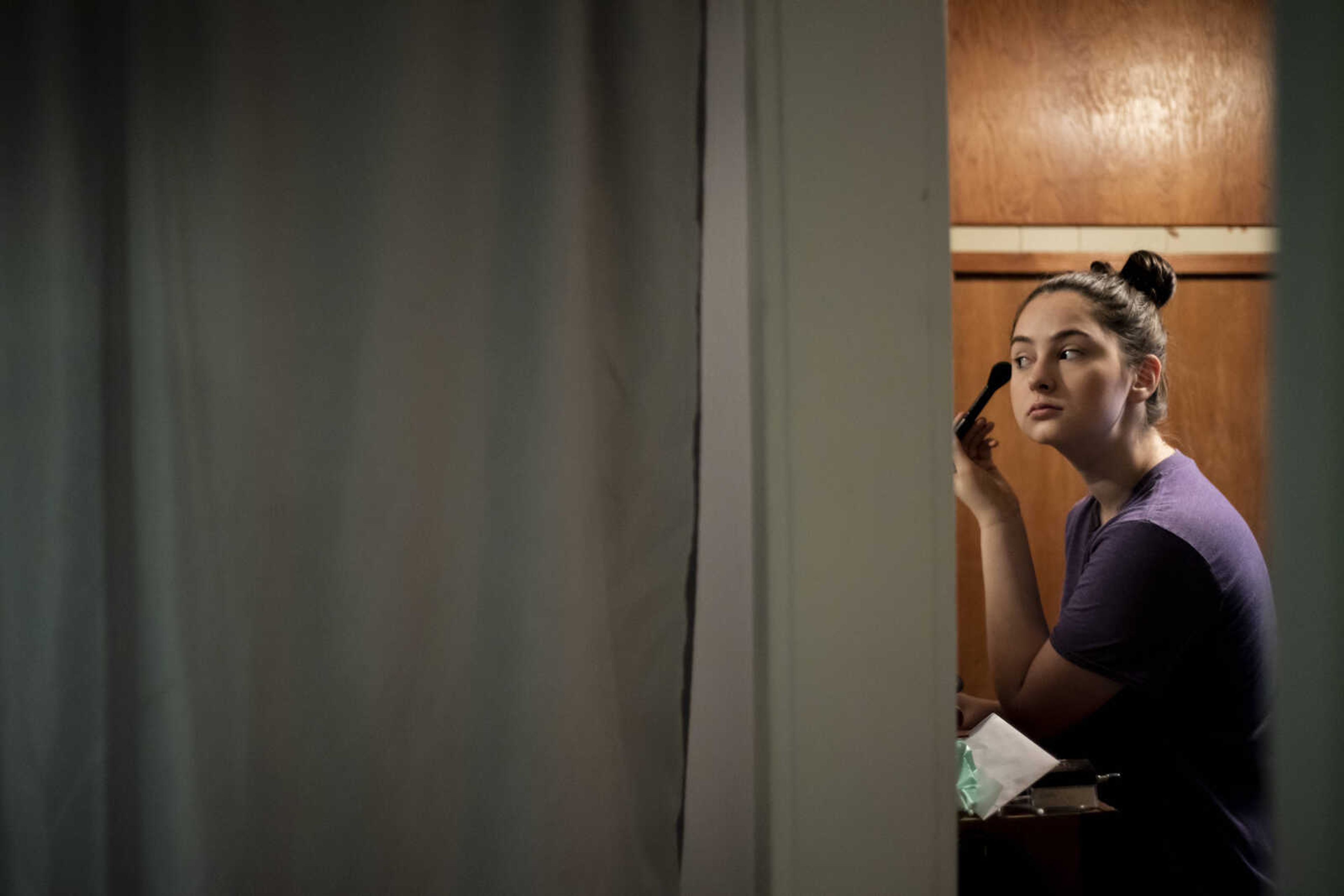 Emily Medlock puts on her makeup the morning of her graduation Sunday, May 12, 2019, at home in Cape Girardeau.