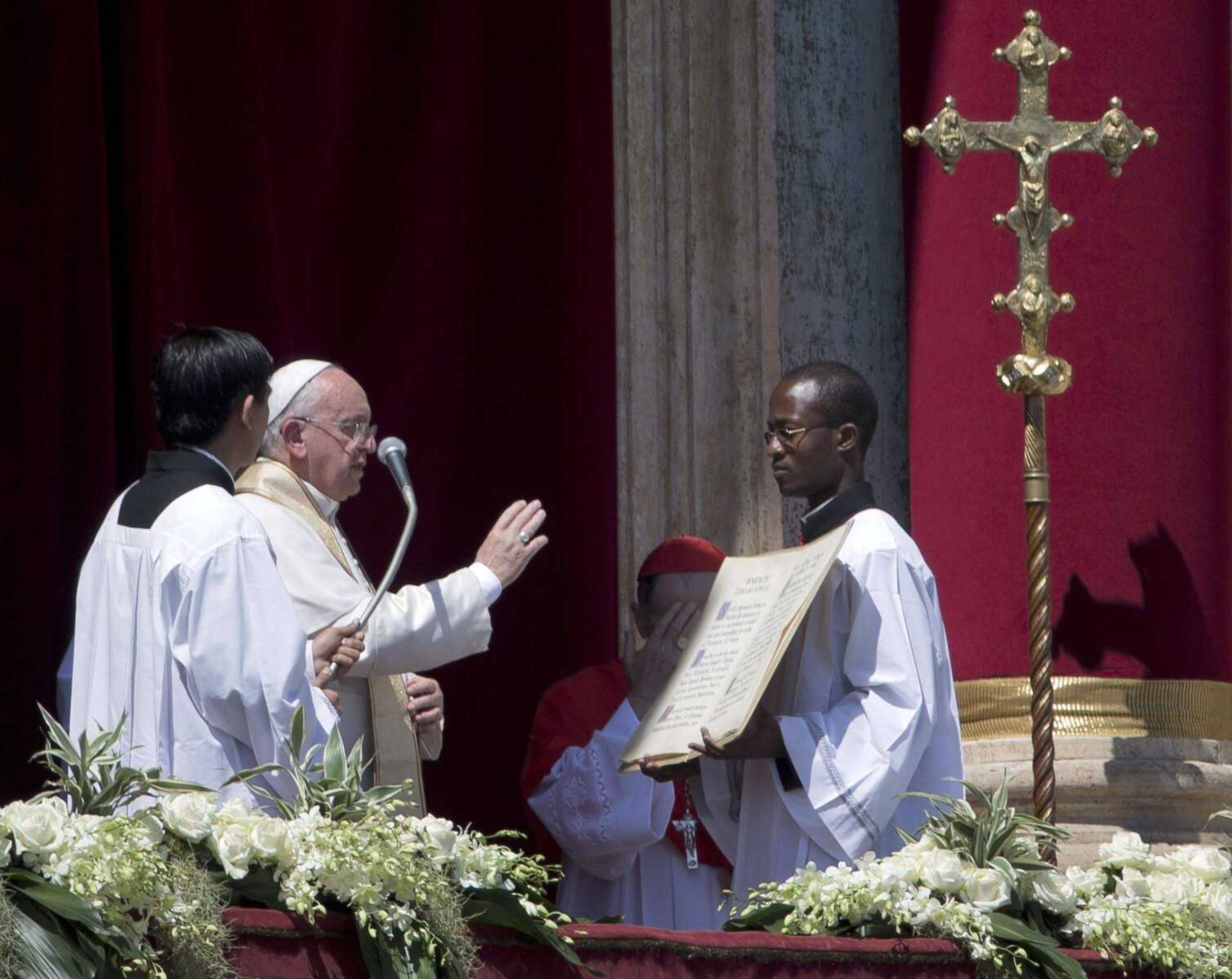 Pope Francis delivers his blessing at the end of the Urbi and Orbi &#8212; Latin for &#8220;to the city and to the world&#8221; &#8212; blessing from the balcony of St. Peter&#8217;s Basilica at the end of the Easter Mass in St. Peter&#8217;s Square on Sunday at the Vatican. (Andrew Medichini ~ Associated Press)