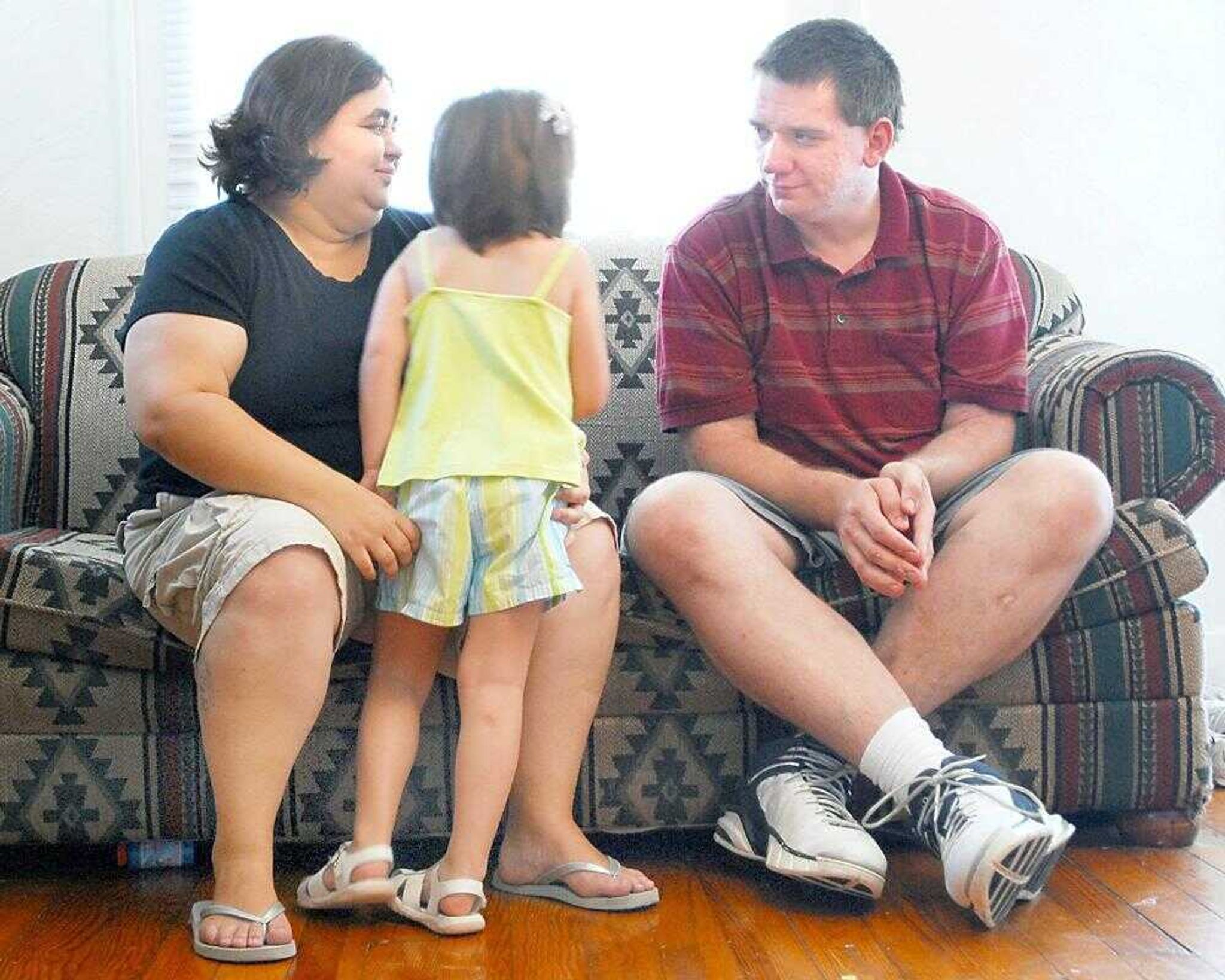 Zoe Dunning talked with her parents, Kimberly Dunning and her boyfriend, Lowell Milner, in the living room of their Cape Girardeau home. (Diane L. Wilson)