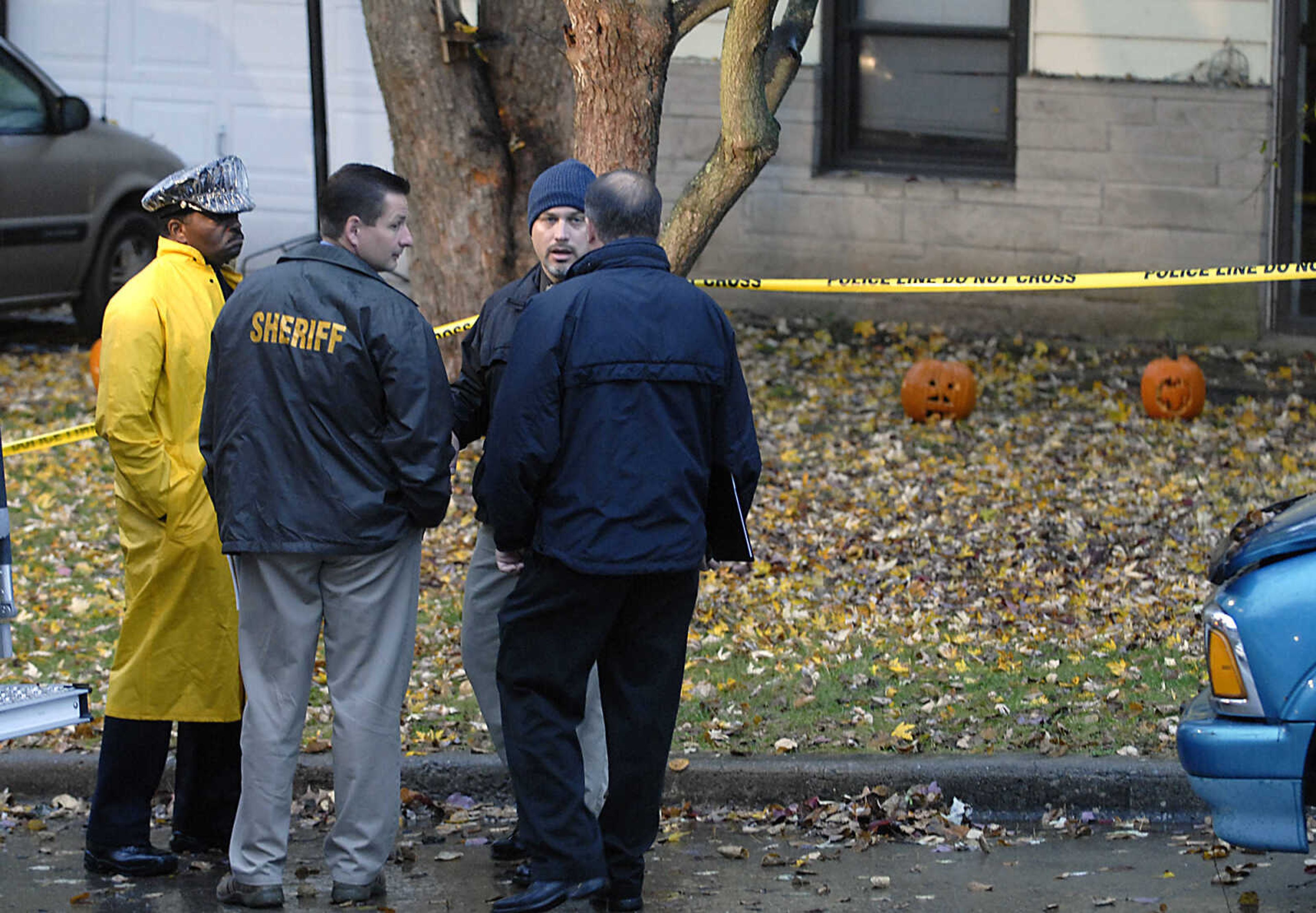 KIT DOYLE ~ kdoyle@semissourian.com
Authorities from several agencies talk outside 1224 N. Missouri St. Tuesday morning, October 27, 2009, in Cape Girardeau.  There was a double homicide at the residence early Tuesday morning.