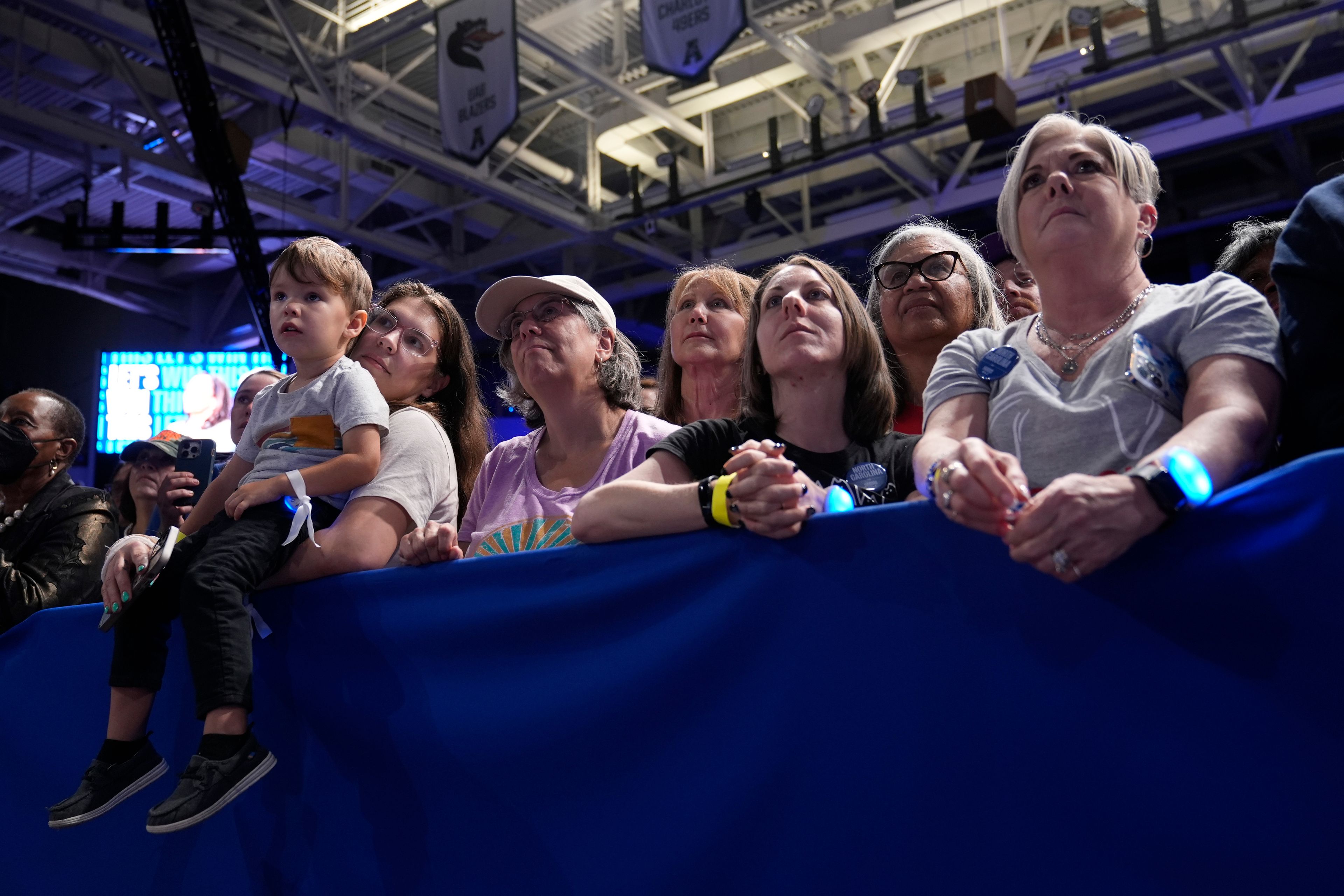 Attendees listen as Democratic presidential nominee Vice President Kamala Harris speaks at a campaign rally at East Carolina University in Greenville, N.C., Sunday, Oct. 13, 2024. (AP Photo/Susan Walsh)