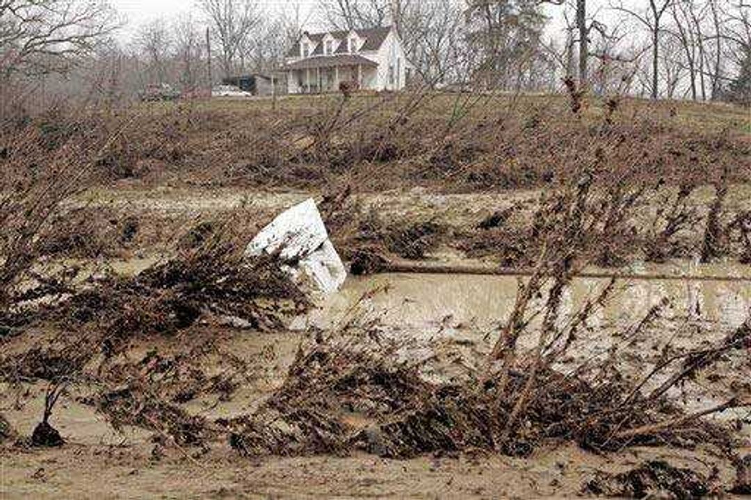 A house sits on a hill in Lesterville, Mo., away from the debris and floodwaters that flowed through the reservoir breach. (Associated Press)