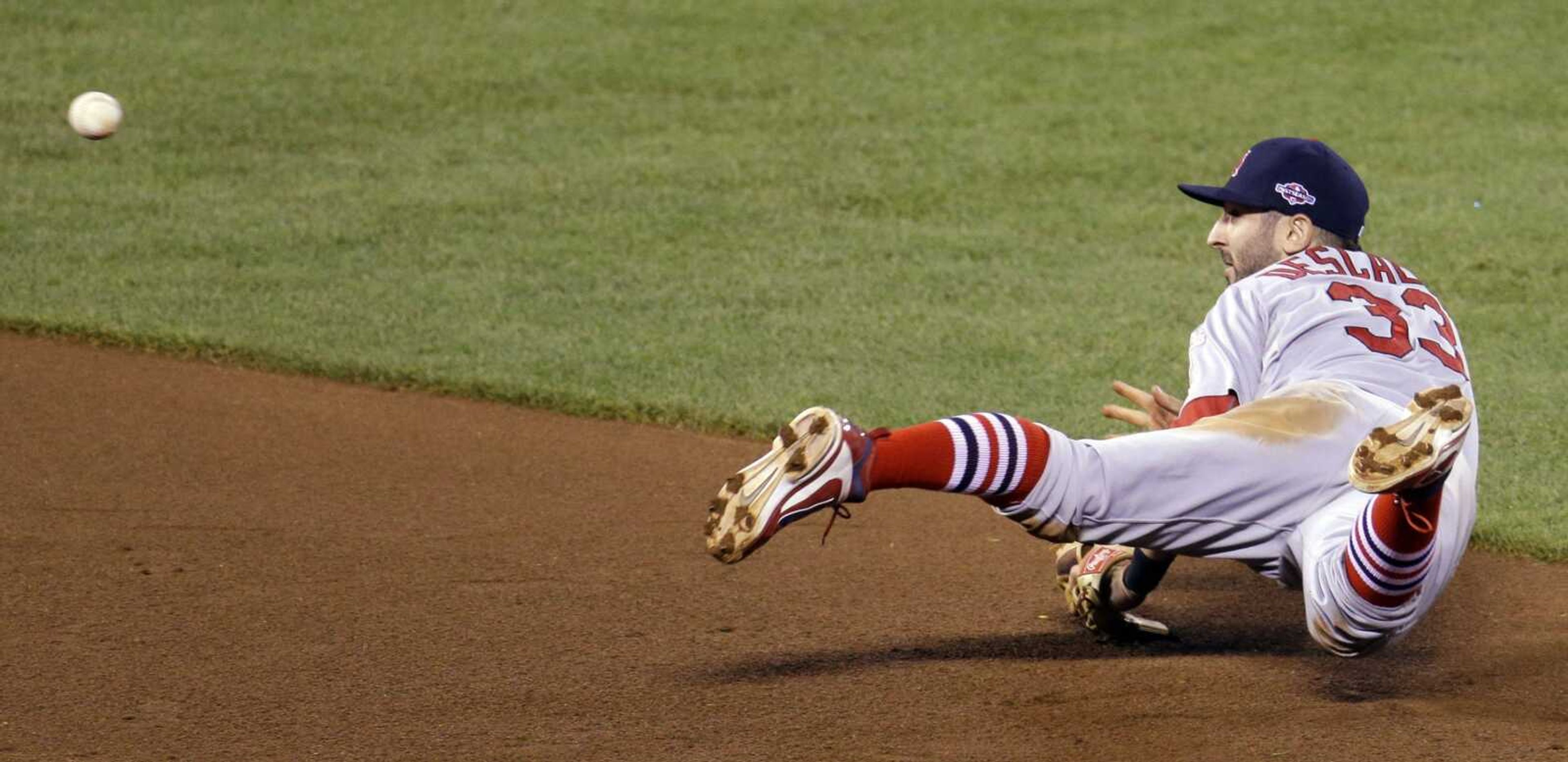 St. Louis Cardinals' Daniel Descalso (33) makes a play on a ball hit by San Francisco Giants' Angel Pagan during the fourth inning of Game 1 of baseball's National League championship series Sunday, Oct. 14, 2012, in San Francisco. (AP Photo/Eric Risberg)