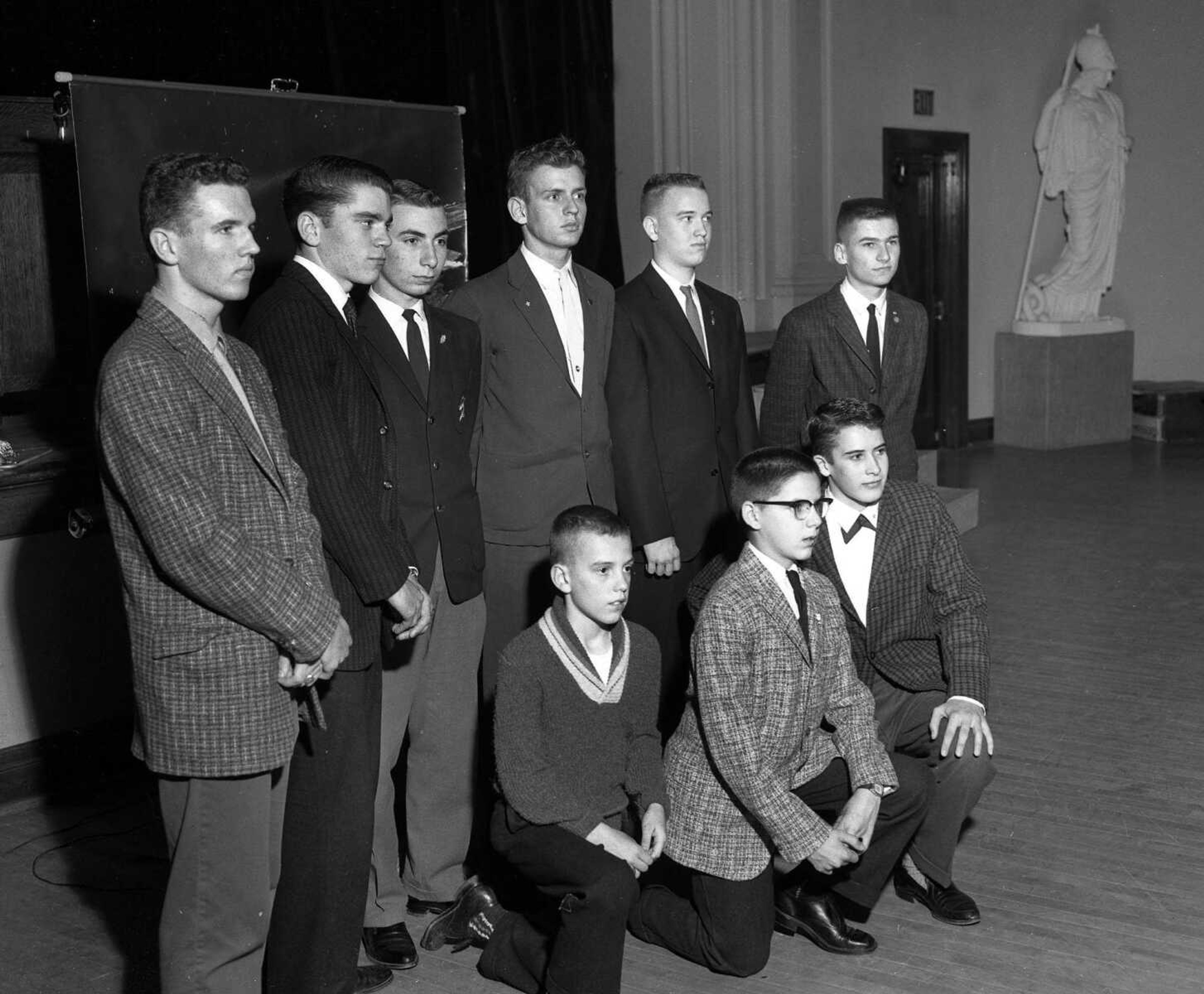 Help us identify these young men posing in front of the stage in Academic Hall's auditorium. Note the statue that towers in the background. It was part of a collection of statues purchased for the university by Louis Houck in 1904.