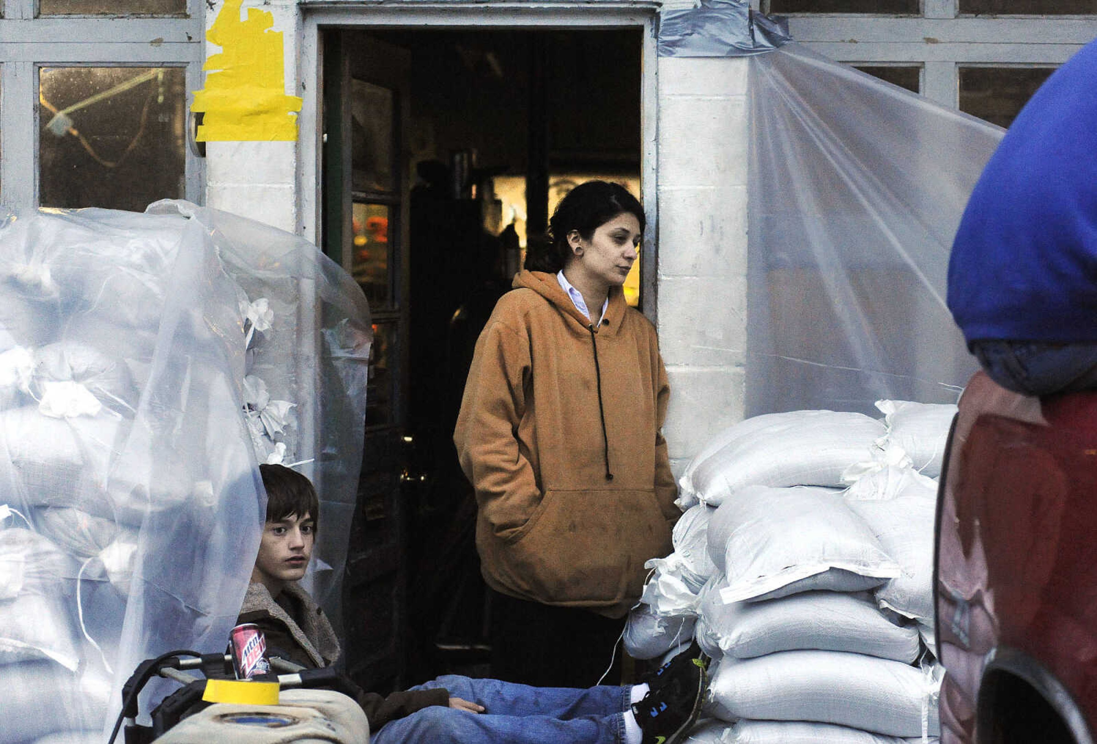 LAURA SIMON ~ lsimon@semissourian.com

Logan Cullum, left, and Victoria Bruce watch as the last of the sandbags are placed around The Rivers Edge near the Red Star Access in Cape Girardeau Tuesday evening, Dec. 29, 2015.