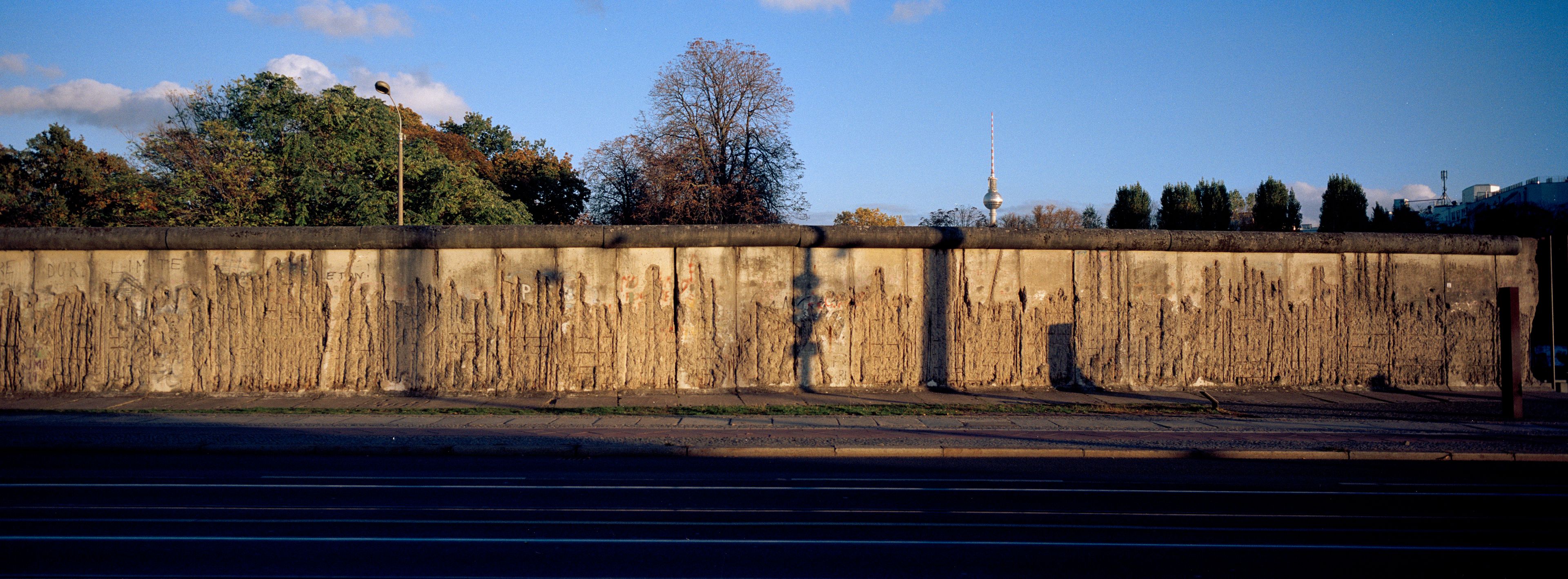 The evening sun lights remains of the Berlin Wall at the official Berlin Wall memorial site at Bernauer Strasse, in Berlin, Germany, Wednesday, Oct. 23, 2024. (AP Photo/Markus Schreiber)