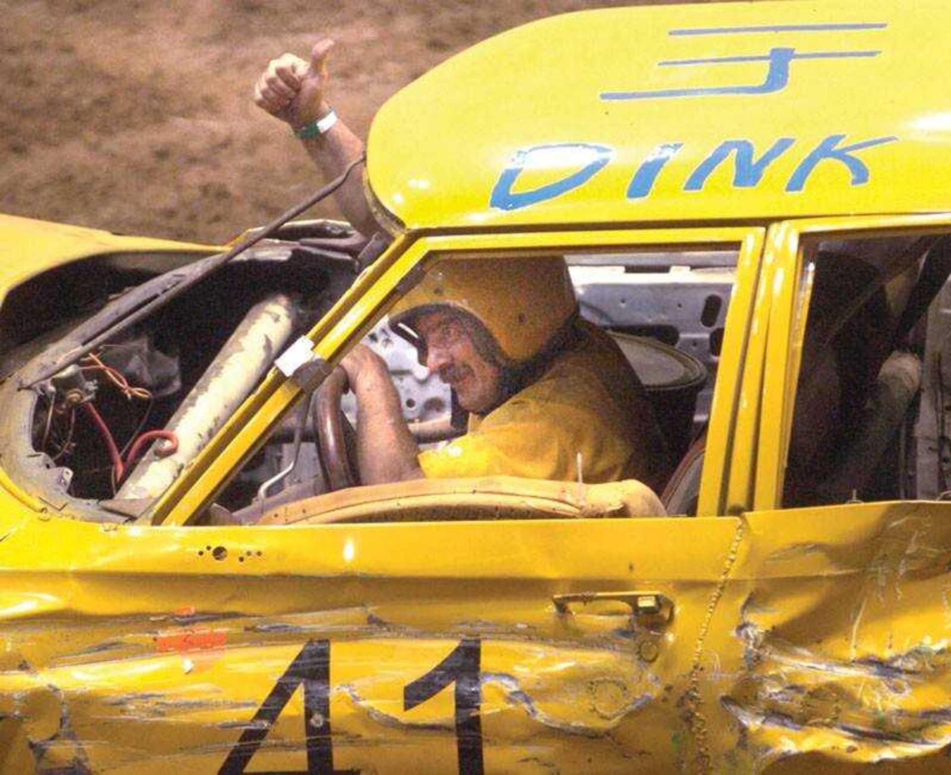 Dink Butler of Piggott, Ark. gave an OK sign after his car was ruled out of commission in the demolition derby. (Fred Lynch)