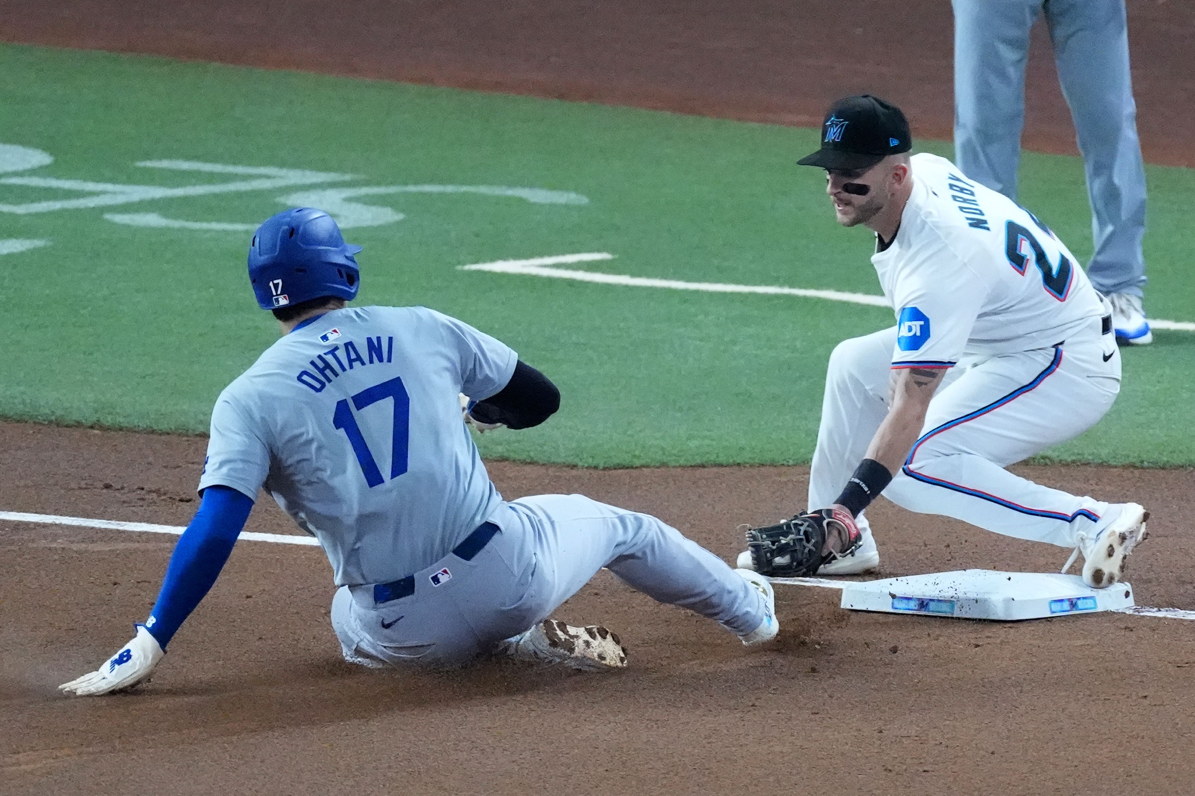 Los Angeles Dodgers' Shohei Ohtani (17) of Japan, steals third base, for his 50th stolen base of the season, as Miami Marlins third baseman Connor Norby attempts the tag during the first inning of a baseball game, Thursday, Sept. 19, 2024, in Miami. (AP Photo/Wilfredo Lee)