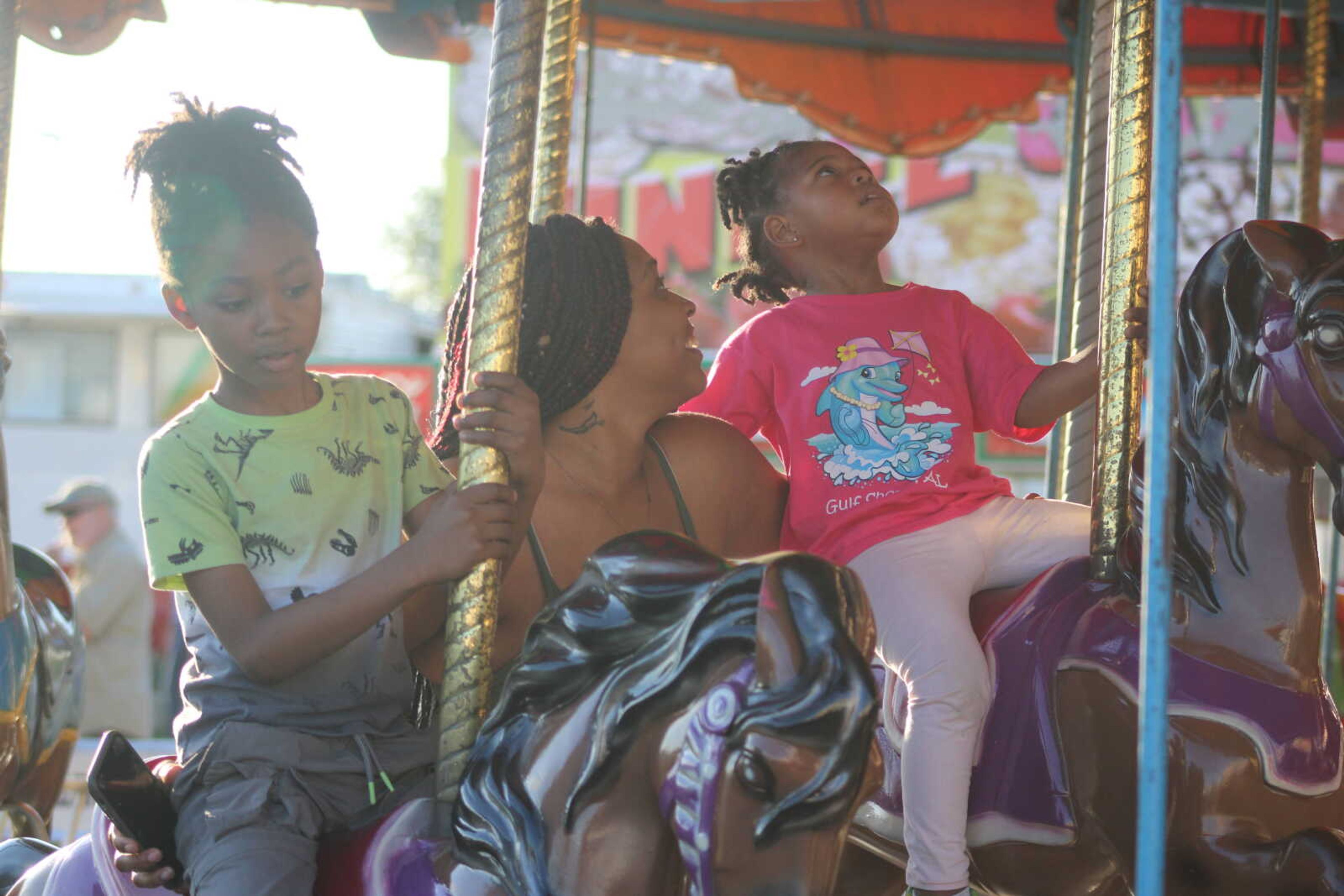 Jamesha Thornton,Ja'mia Anderson and Anton Wilbourn take a ride on the carousel.&nbsp;