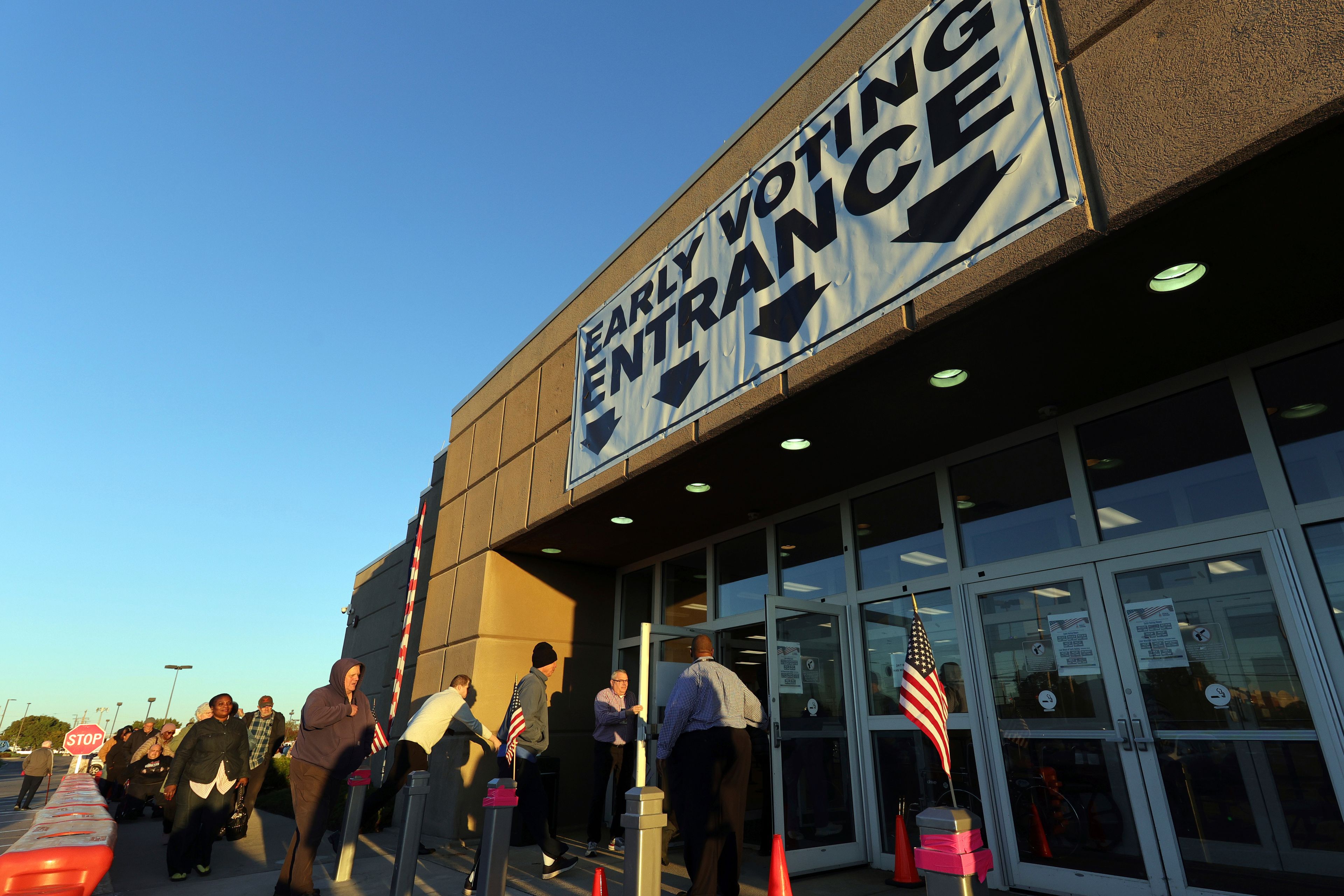 Voters enter the early voting center for the first day of in person early voting at the Franklin County Board of Elections in Columbus, Ohio, Tuesday, Oct. 8, 2024. (AP Photo/Paul Vernon)