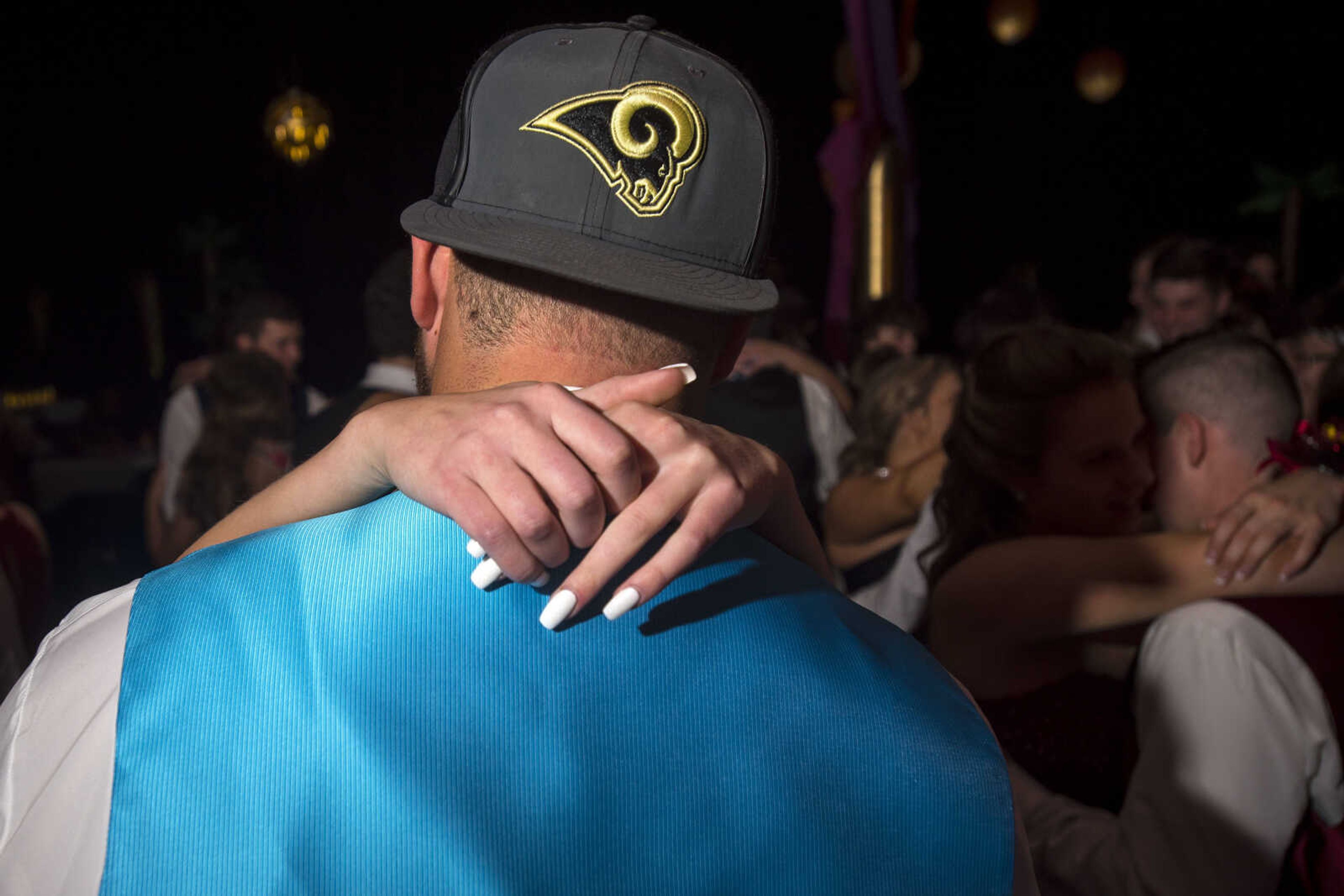 Courtney Jarrett wraps her arms around Levi Watkins's neck as the two dance during prom Saturday, April 6, 2019, at Kelly High School in Benton.