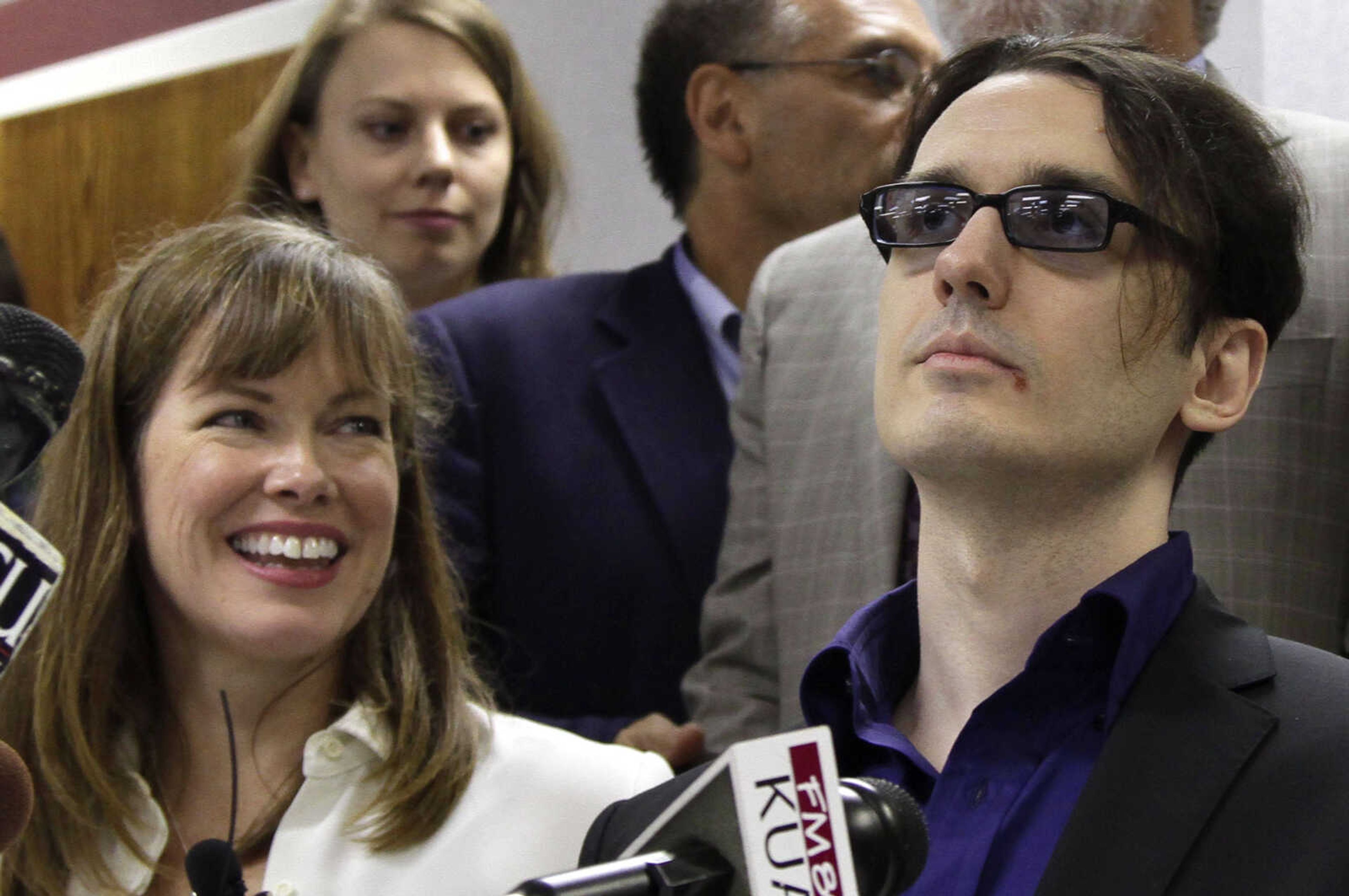 Damien Echols, right, and his wife Lorri attend a news conference at the Craighead County Court House in Jonesboro, Ark., Friday, Aug. 19, 2011, after Echols and two other men entered guilty pleas to to crimes they say they did not commit in order to be set free. The defendants, known by their supporters as the West Memphis 3, agreed to a legal maneuver that lets them maintain their innocence while acknowledging prosecutors have enough evidence against them.  (AP Photo/Danny Johnston)