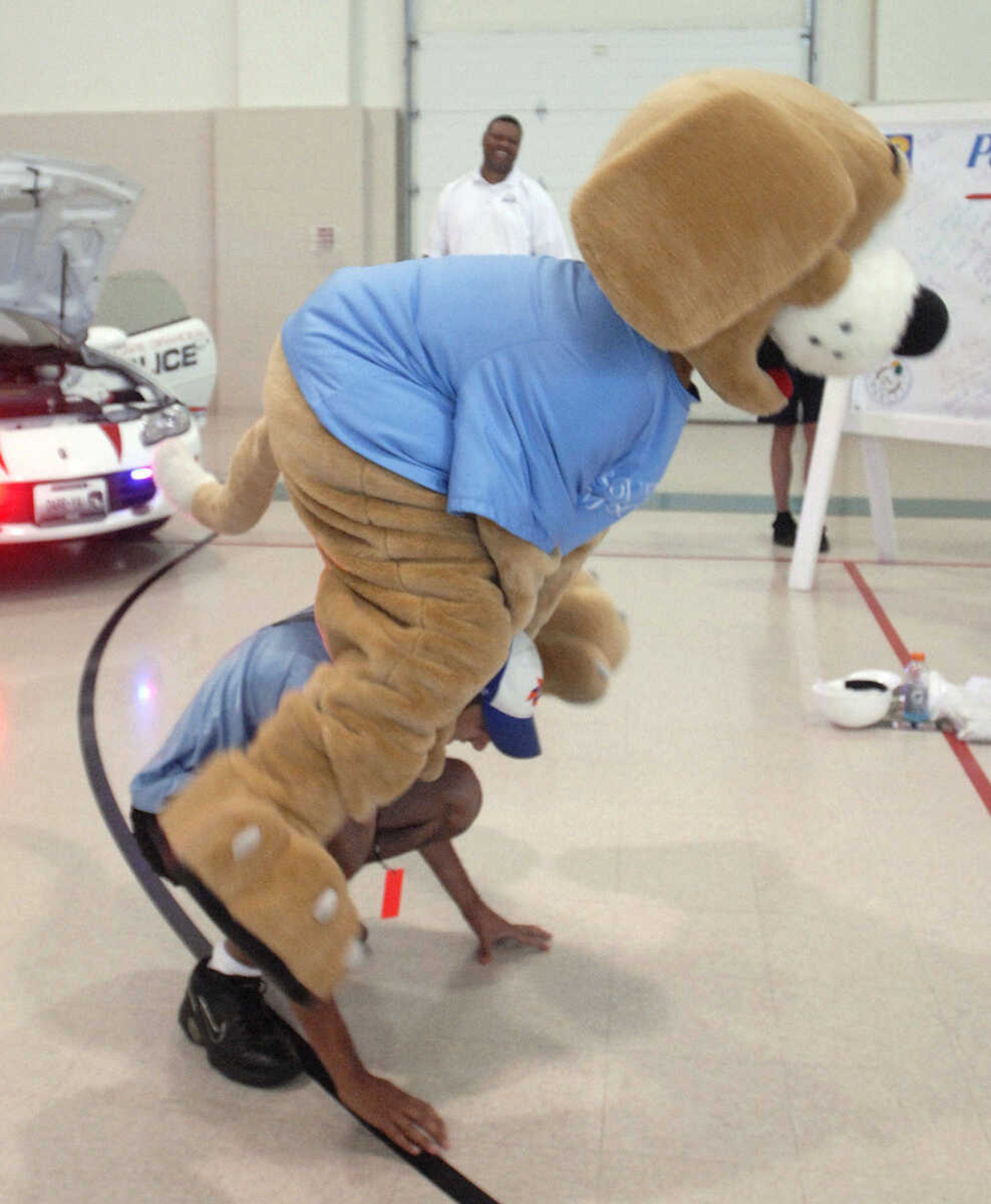 LAURA SIMON ~ lsimon@semissourian.com
Tracker plays leap frog with a Special Olympic athlete at Victory Village inside the the Osage Centre Saturday, August 13, 2011 in Cape Girardeau.